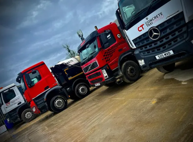 Smiling construction professionals exchanging a handshake as part of their partnership on site