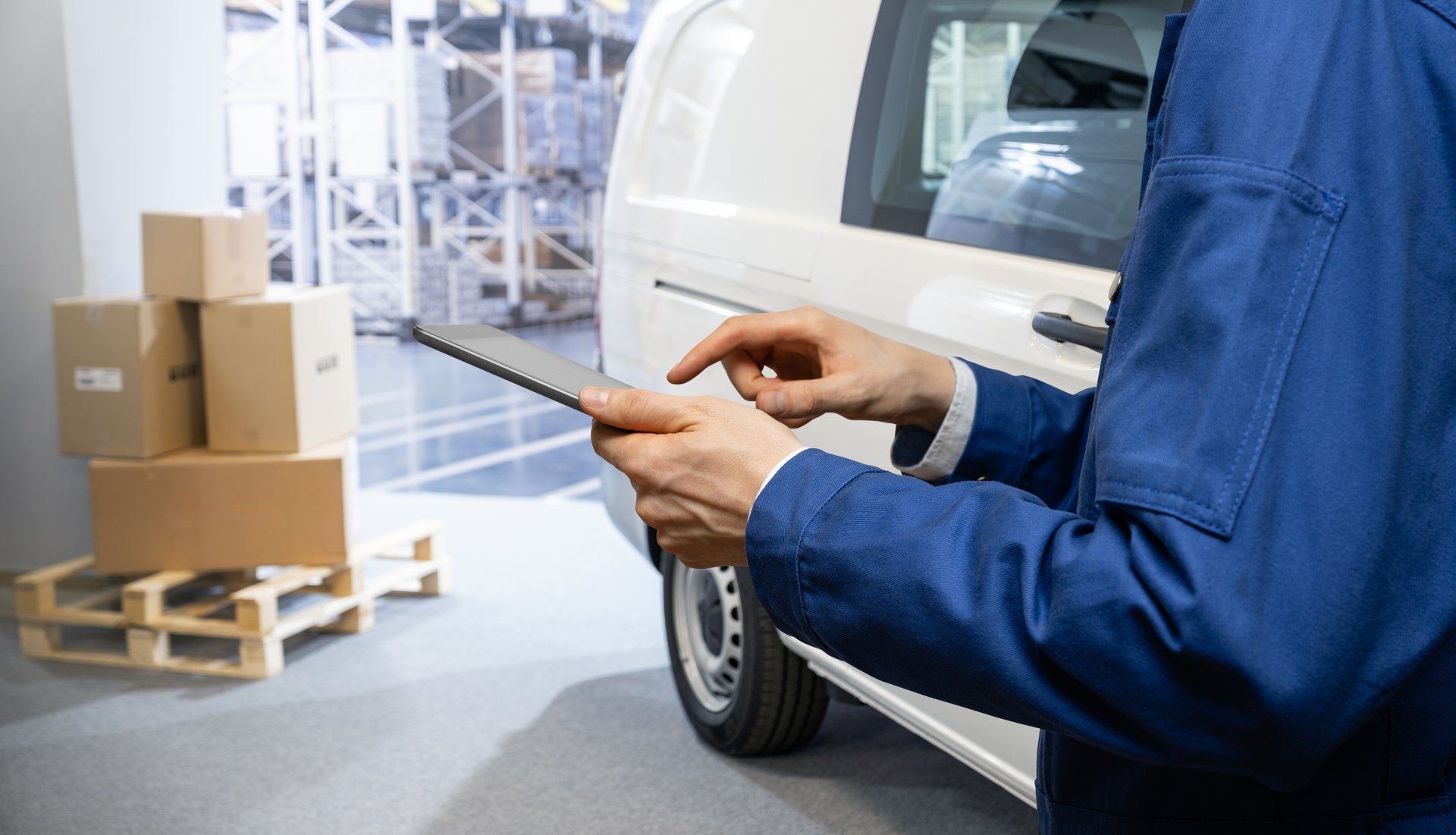 Manager with a digital tablet on the background of van. Fleet and warehouse management