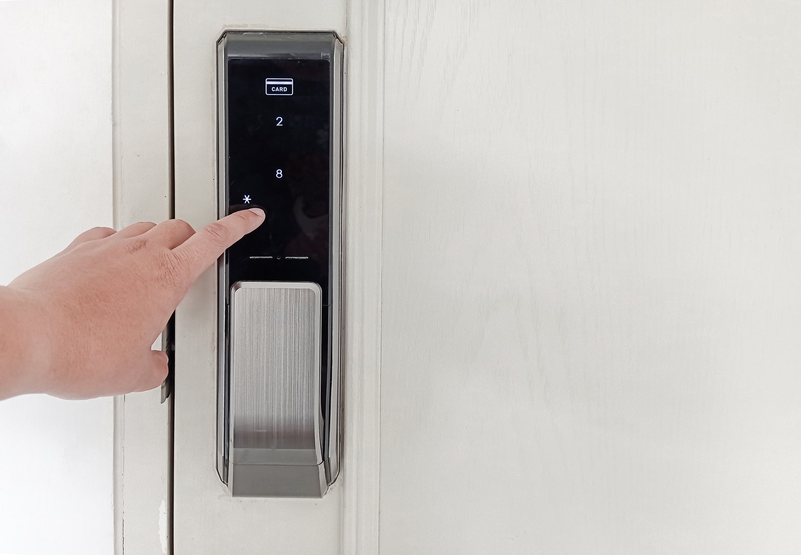 Home security system. hand pressing password code to lock and unlock door . entering code Door access control on smart digital touch screen keypad with keycard reader of home security alarm.