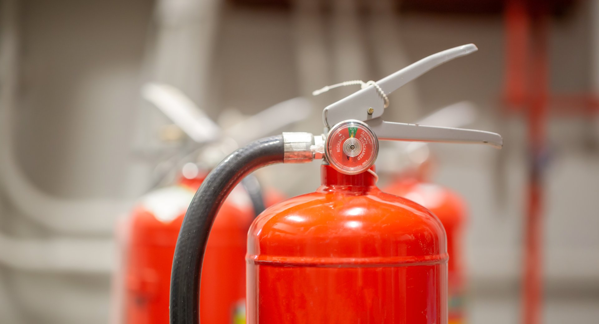 The red fire extinguisher is in the building for fire prevention and safety.