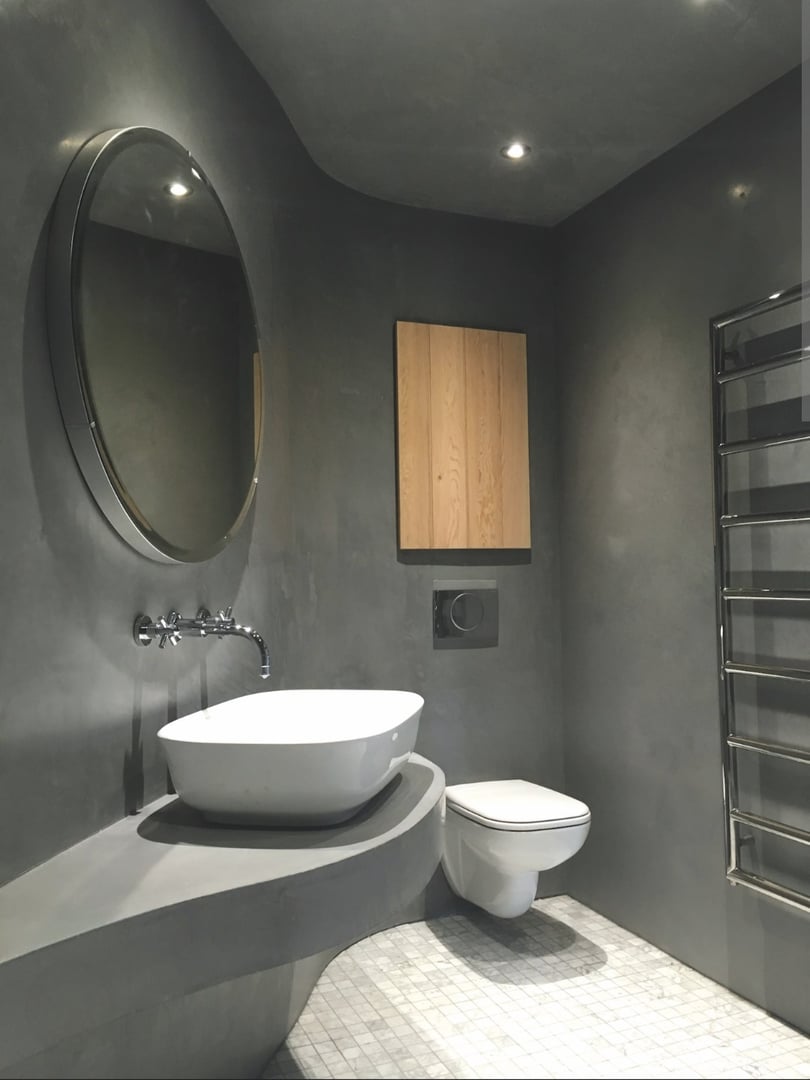 Plastering the wall using a trowel and starting plaster. The process of applying the starting plaster to the wall using a trowel.