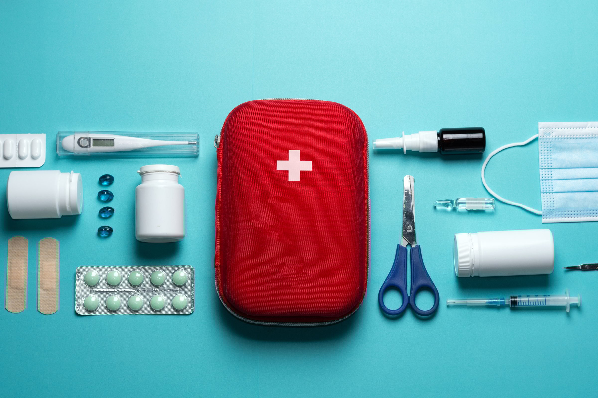 Home first aid kit on blue background elements of the first aid kit