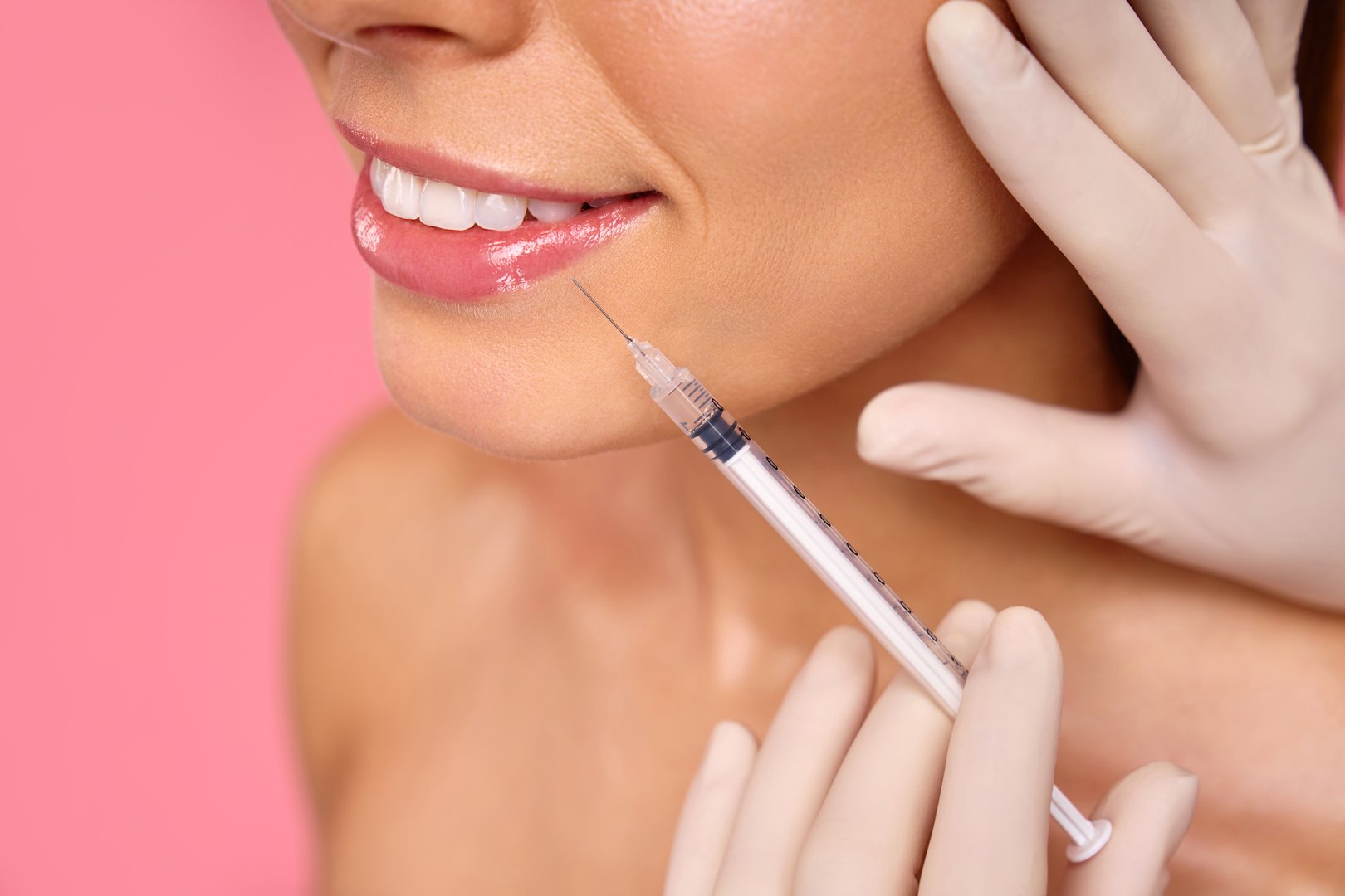 The image depicts a woman undergoing a cosmetic procedure for lip enhancement or skin rejuvenation with injectables in a clinical setting, aiming to enhance her lips appearance and youthfulness