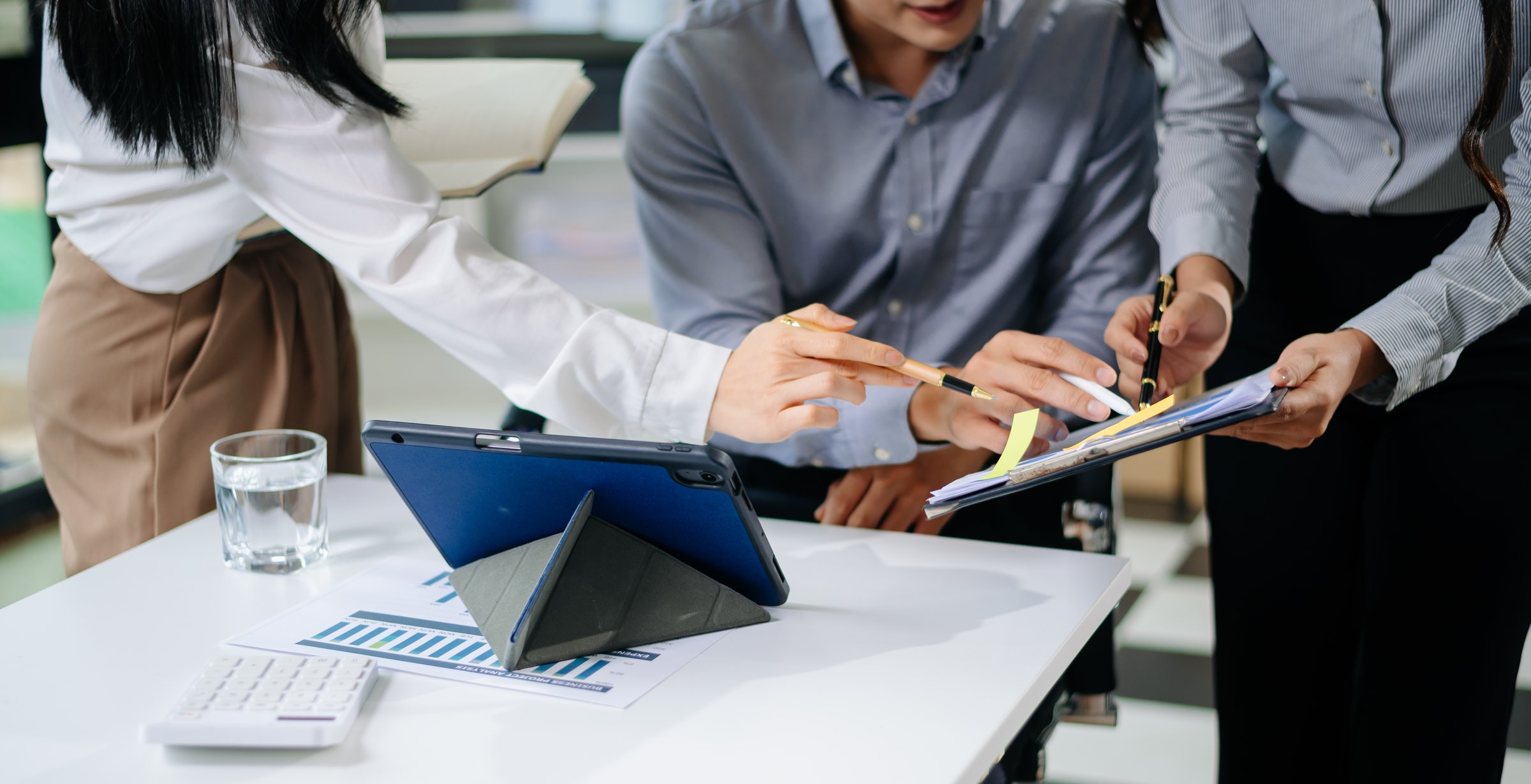Business team collaboration discussing working analyzing with financial data and marketing growth report graph in team, presentation and digital tablet, laptop