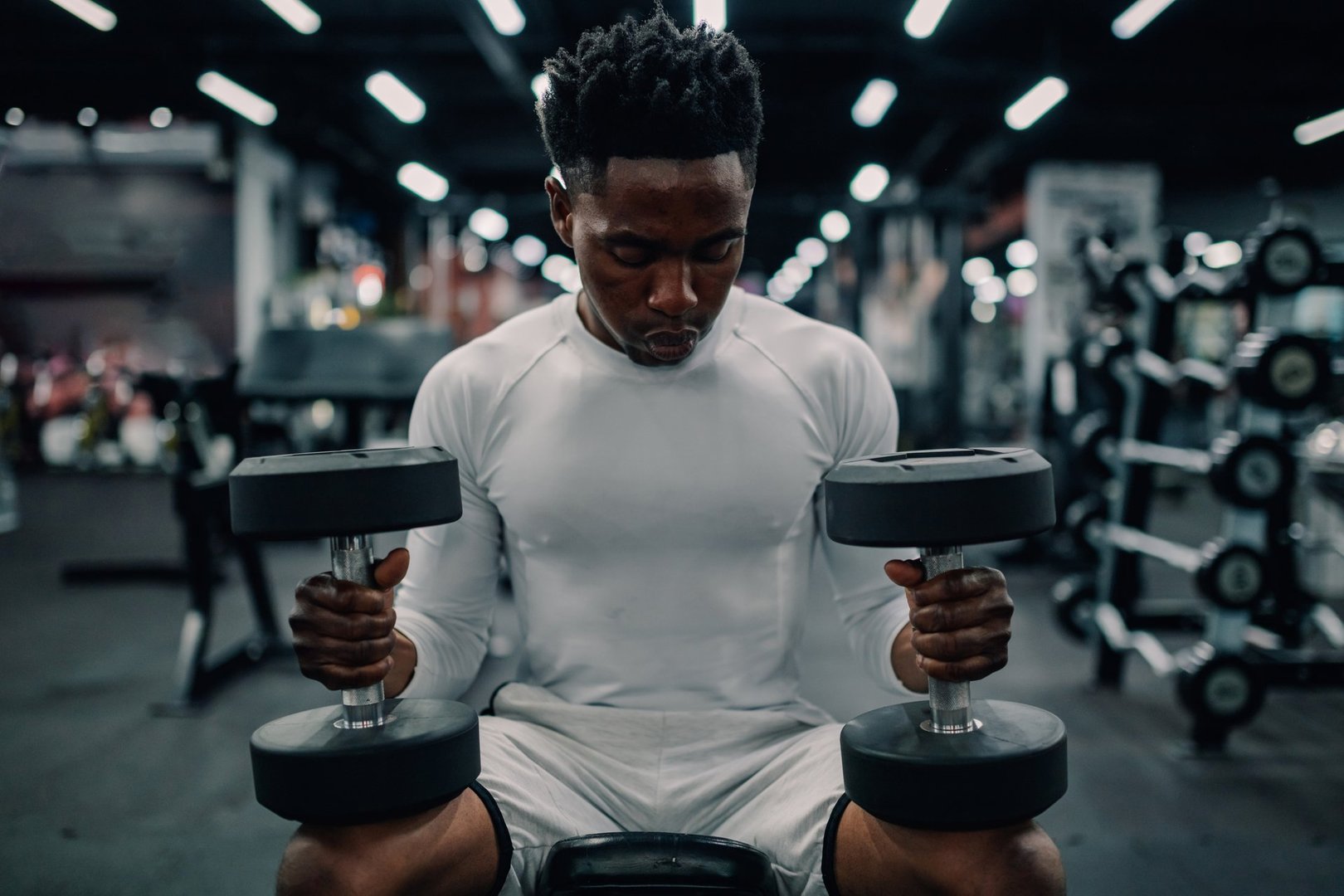 Young athlete lifting dumbbells