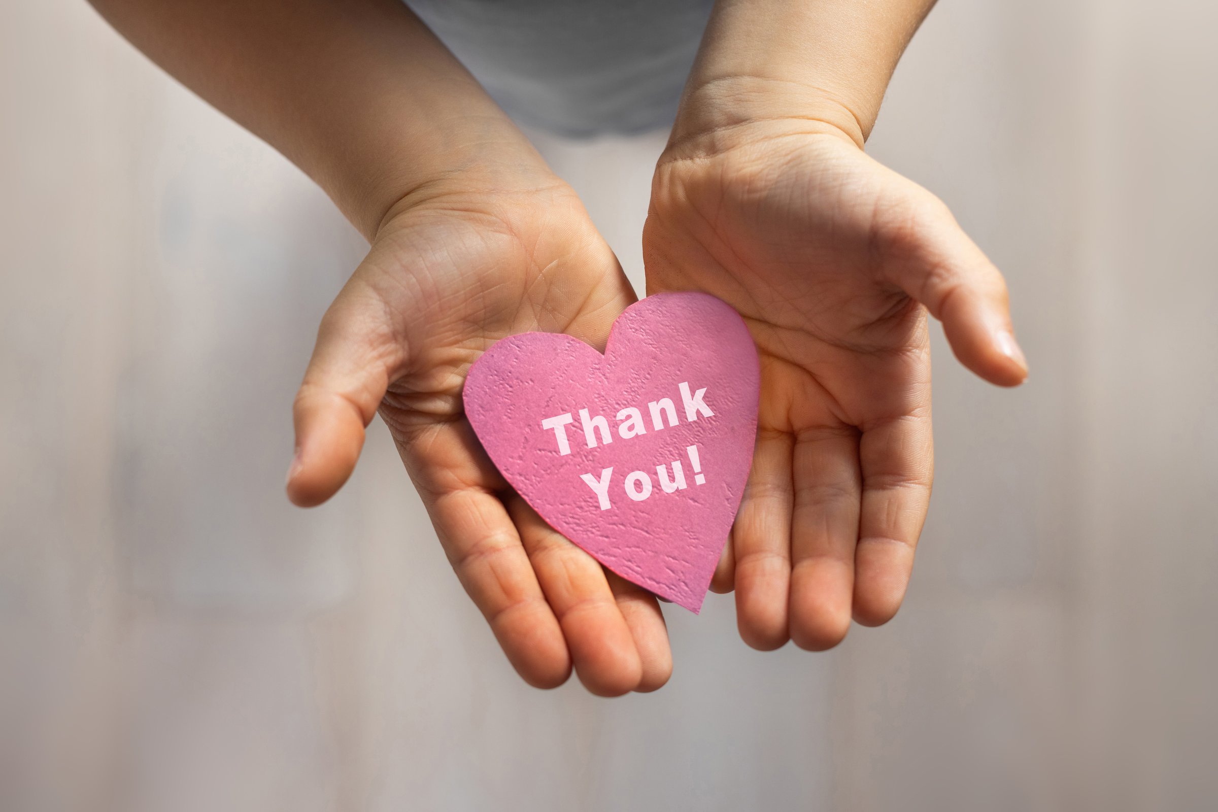 thank you card, gratitude concept, child hands holding pink paper heart with thanks appreciation message