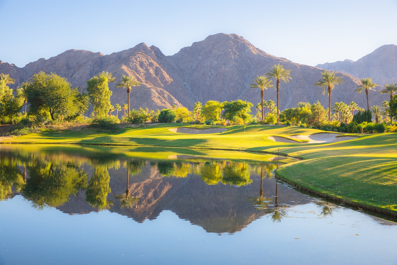 Beautiful golden light over Indian Wells Golf Resort, a desert golf course in Palm Springs, California, USA with view of the San Bernardino Mountains.