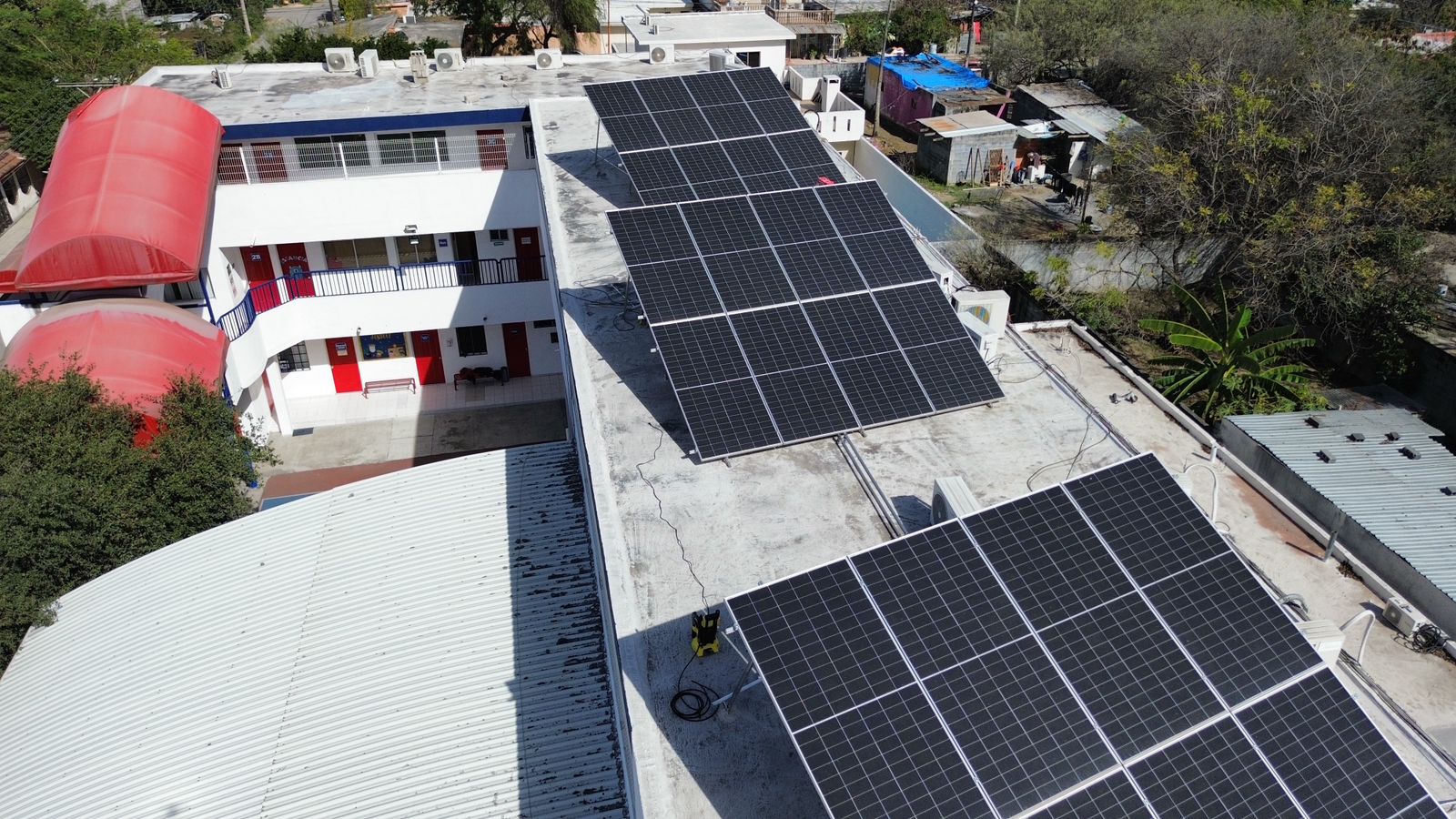 Solar Panel Roof Building on Skyscrapers Background with Sun Reflection. Solar Panels on Roof Residential Building.