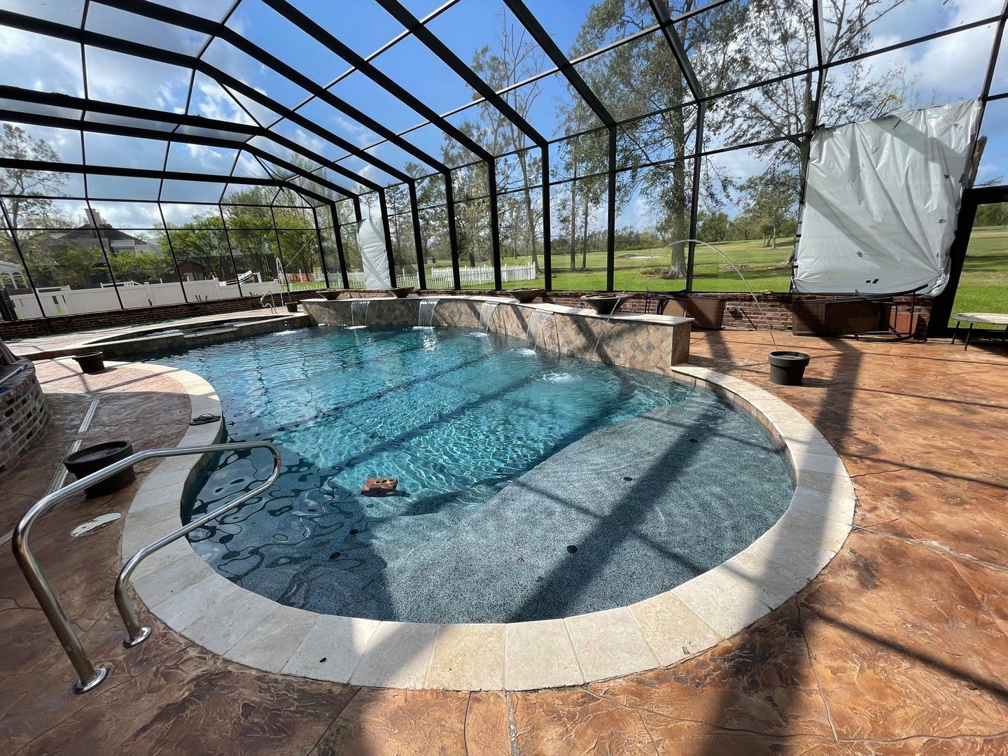 New pool installation Louisiana - modern pool with lounge chairs and palm trees