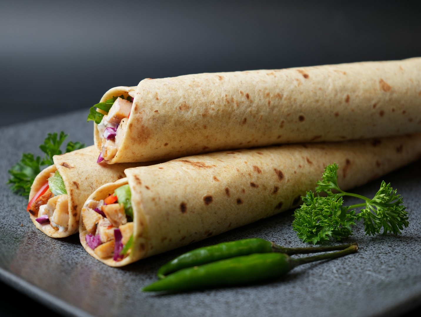 These chicken wraps are filled with fresh vegetables, showcasing a vibrant mix of colors and textures, perfect for a healthy and tasty meal that's easy to enjoy.