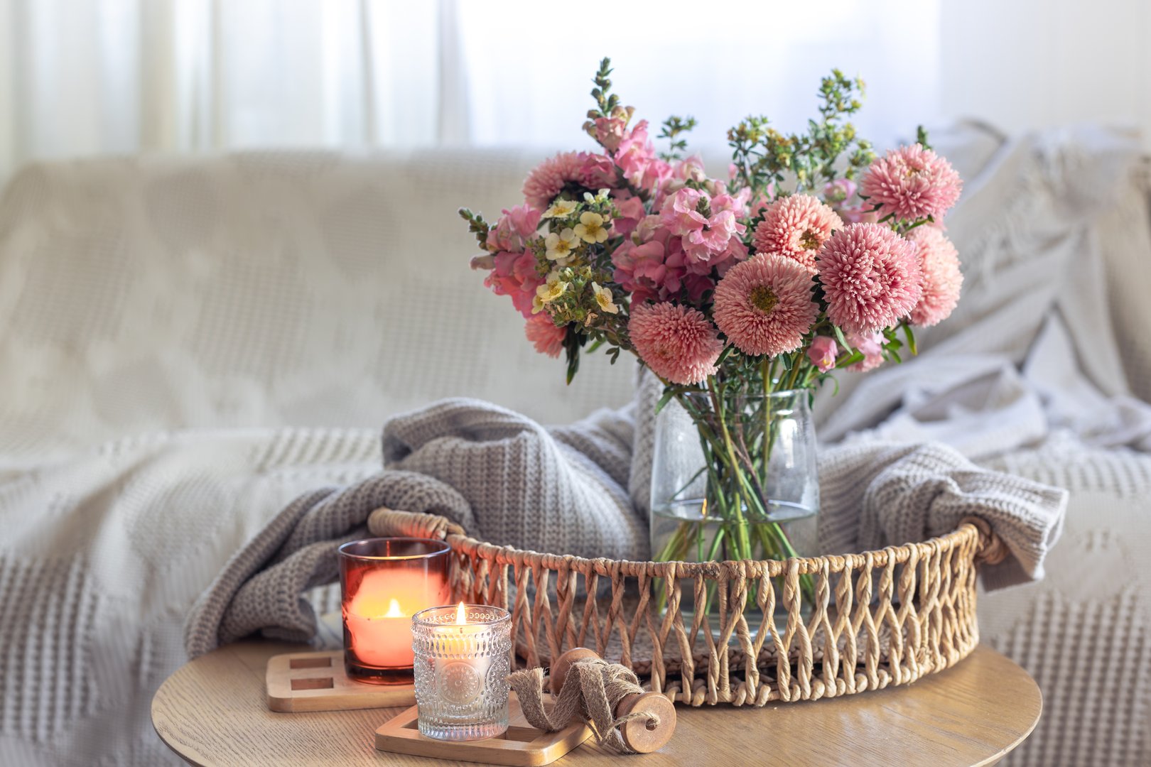Cozy home interior with flowers dahlias and candles. Autumn home comfort. High quality photo