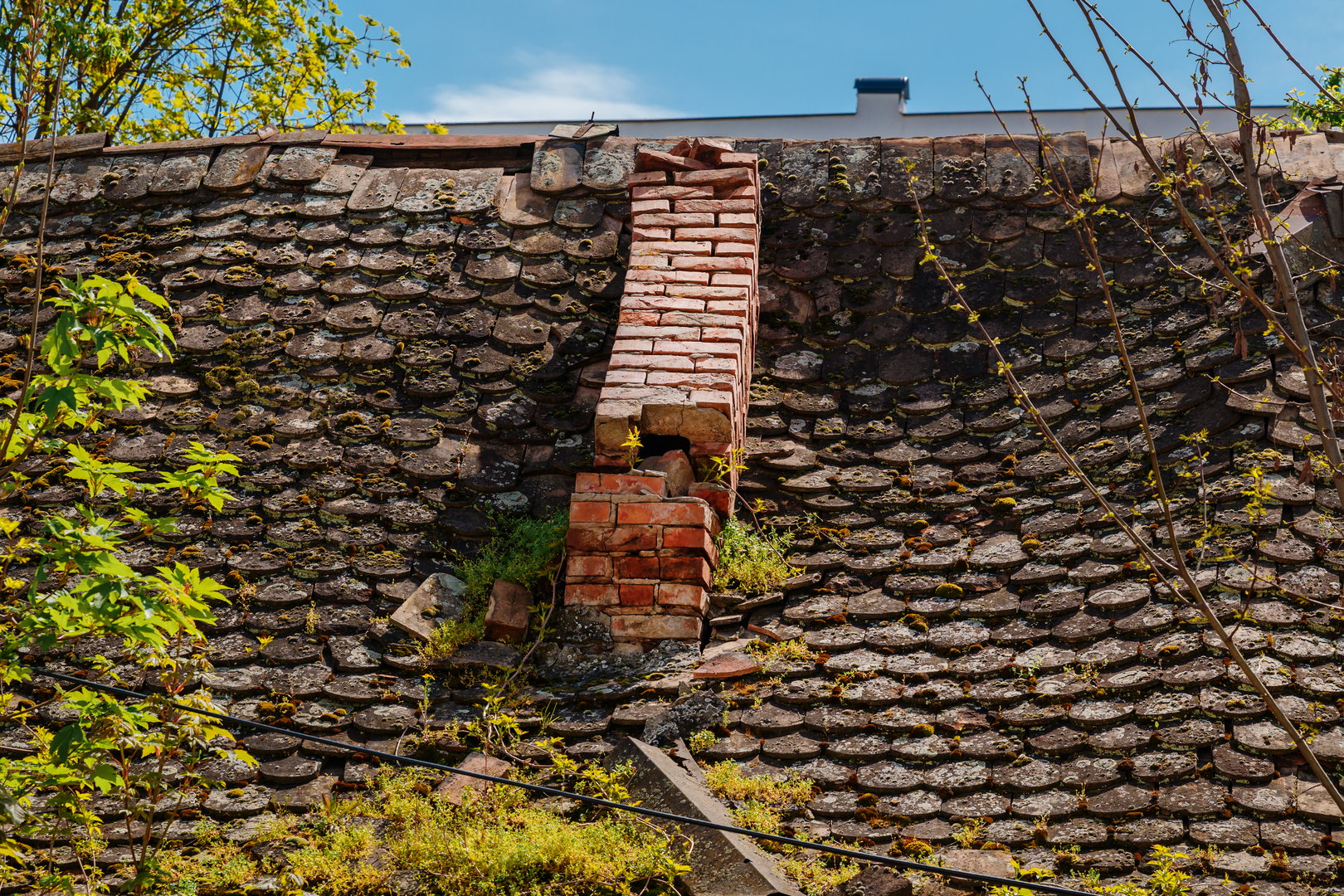 Old house brick chimney smoke stack ruined and damaged, selective focus