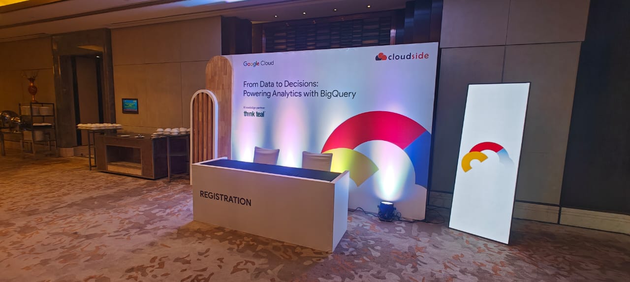 Conference registration table with a Google Cloud and Cloudside banner, and BigQuery event signage in a hotel setting.