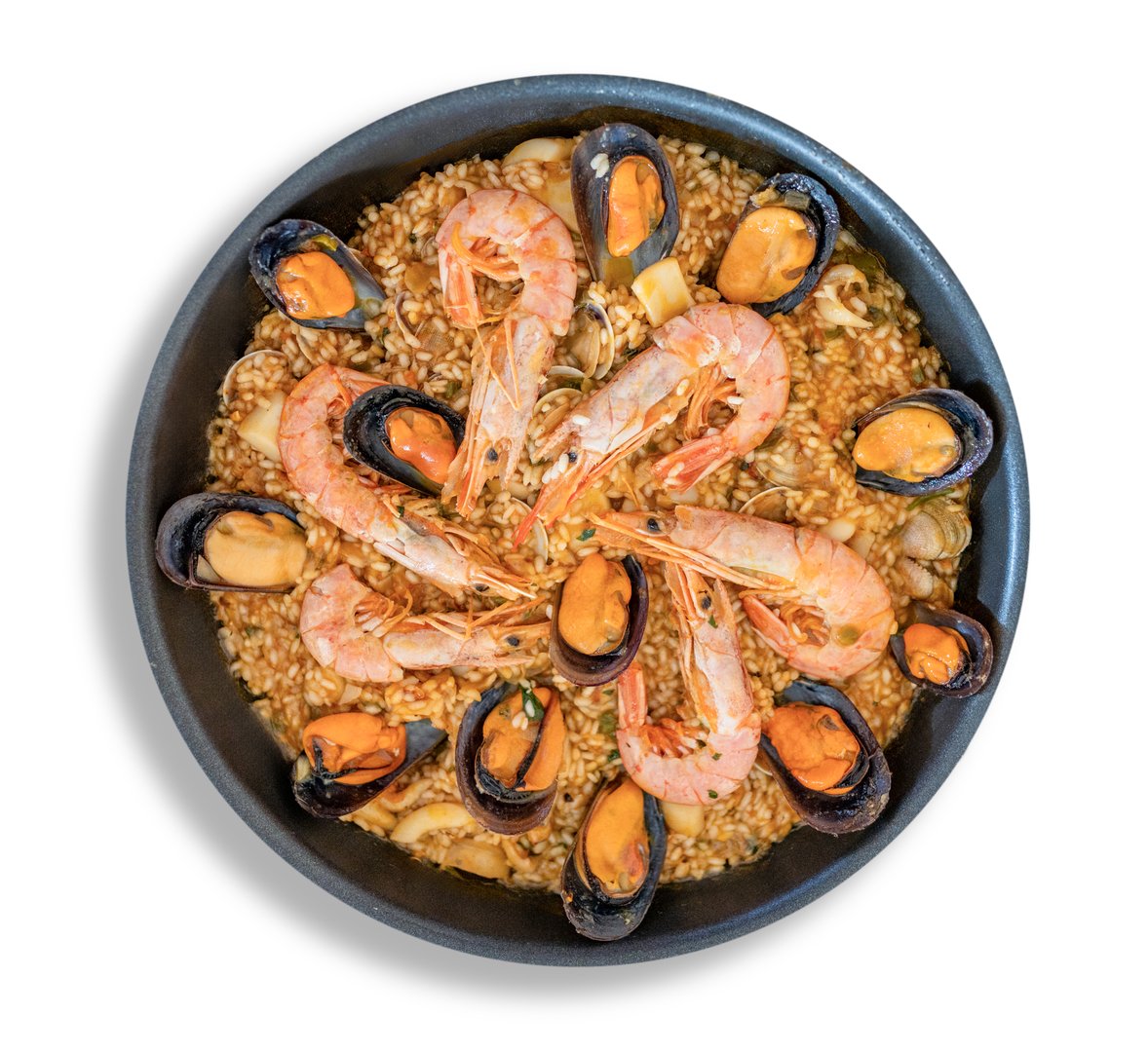 Traditional spanish paella with seafood, rice, shrimps, and mussels, served in a pan