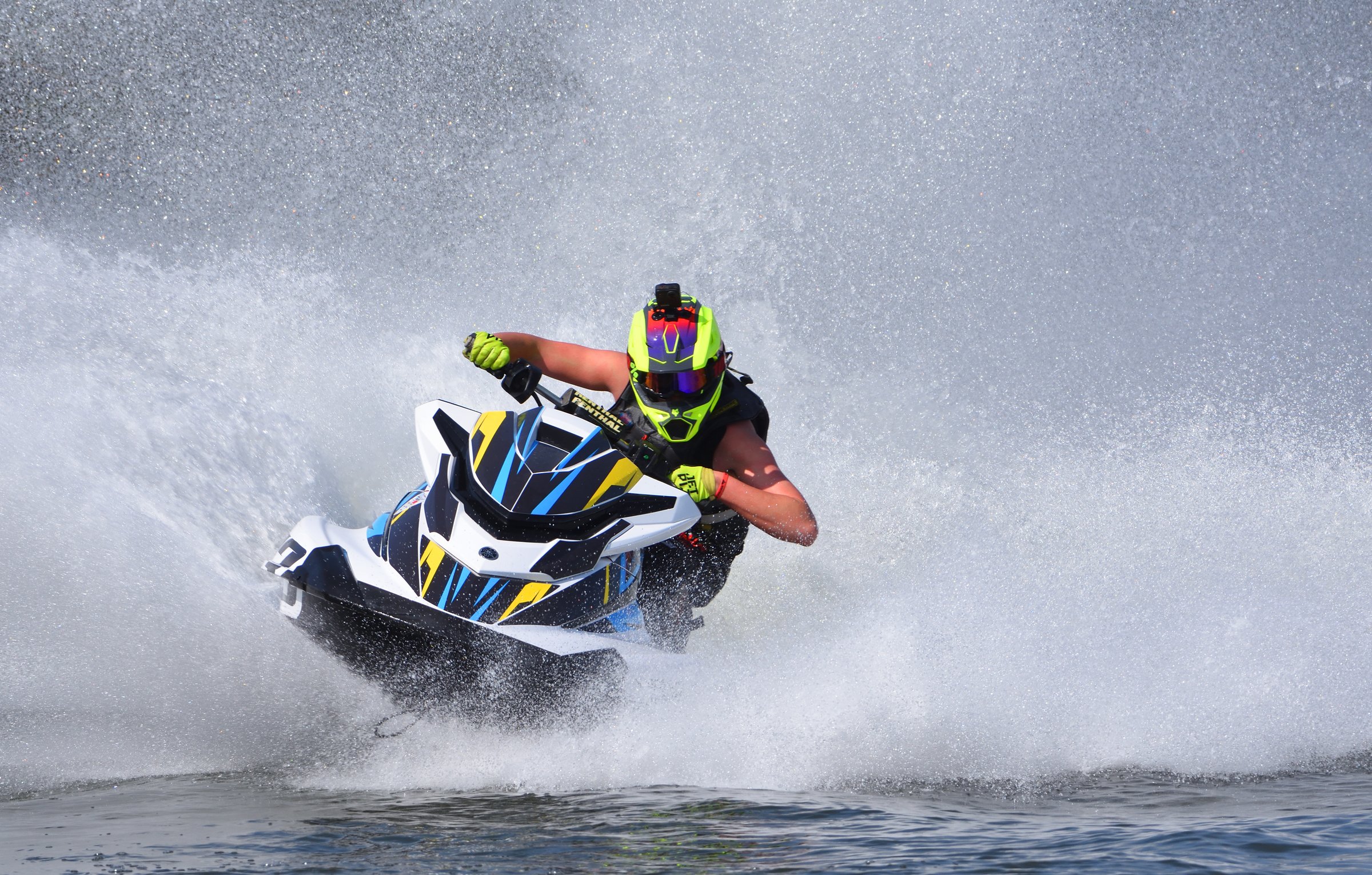 Wyboston, Bedfordshire, England - April 12, 2025:  Jet Ski racer cornering at speed creating a lot of spray