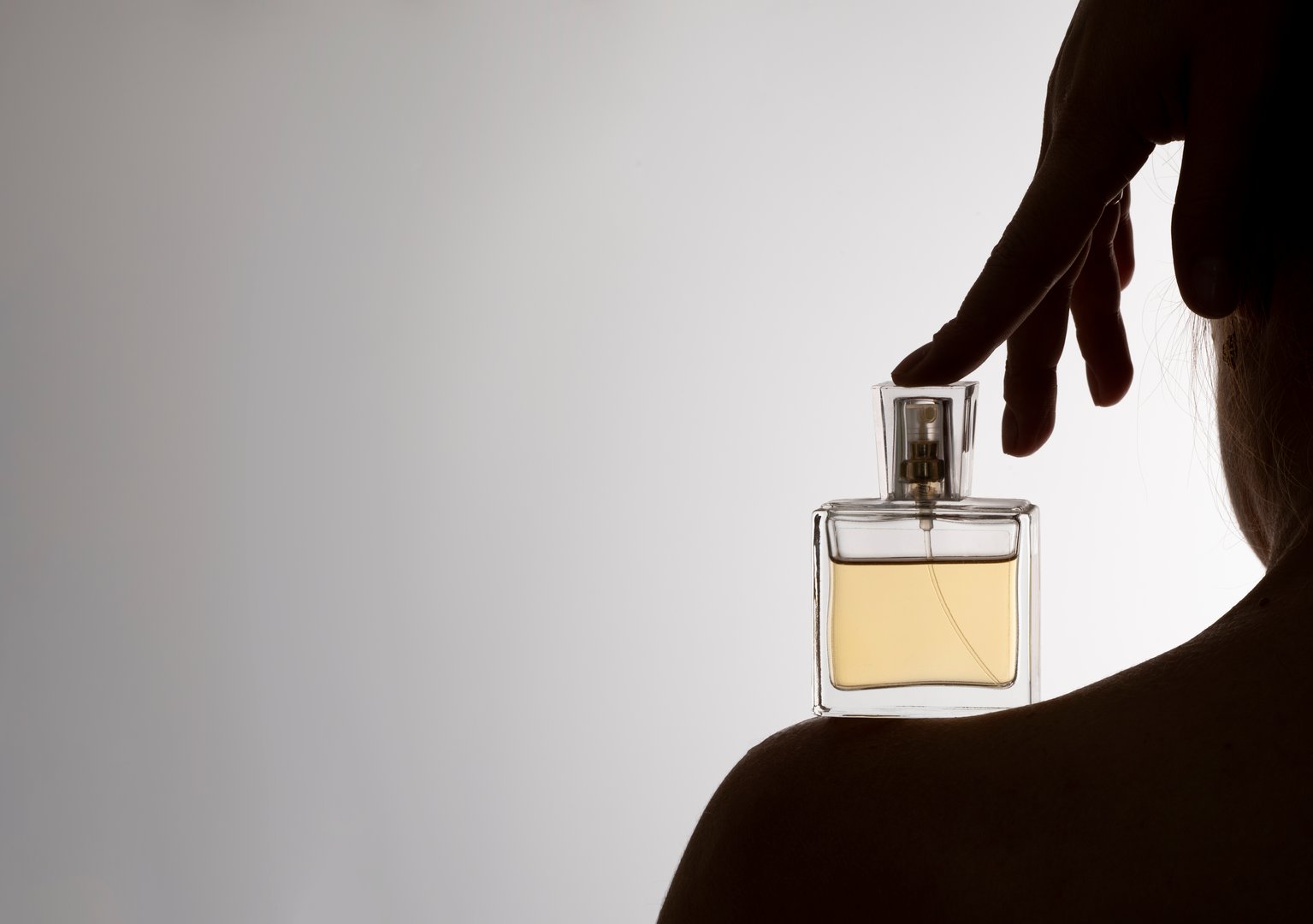 Photo of perfume on a woman's silhouette