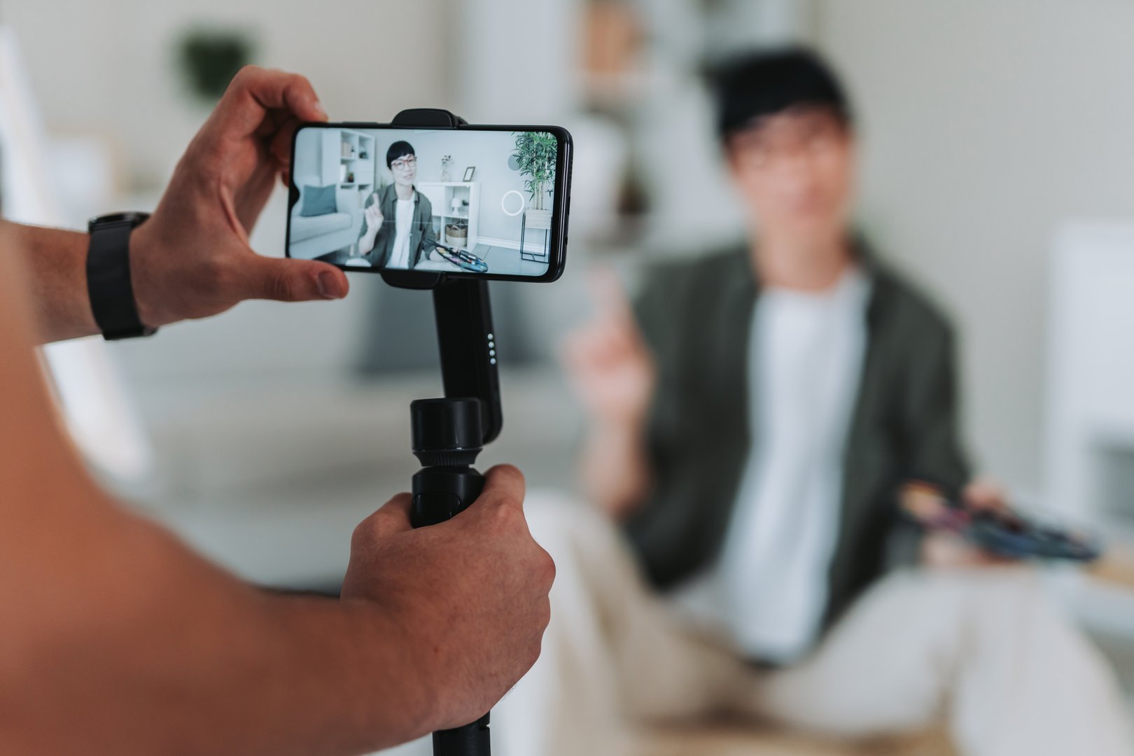 Close-up of a man hands holding a smart phone gimbals, recording an influence creating engaging content for social media platforms
