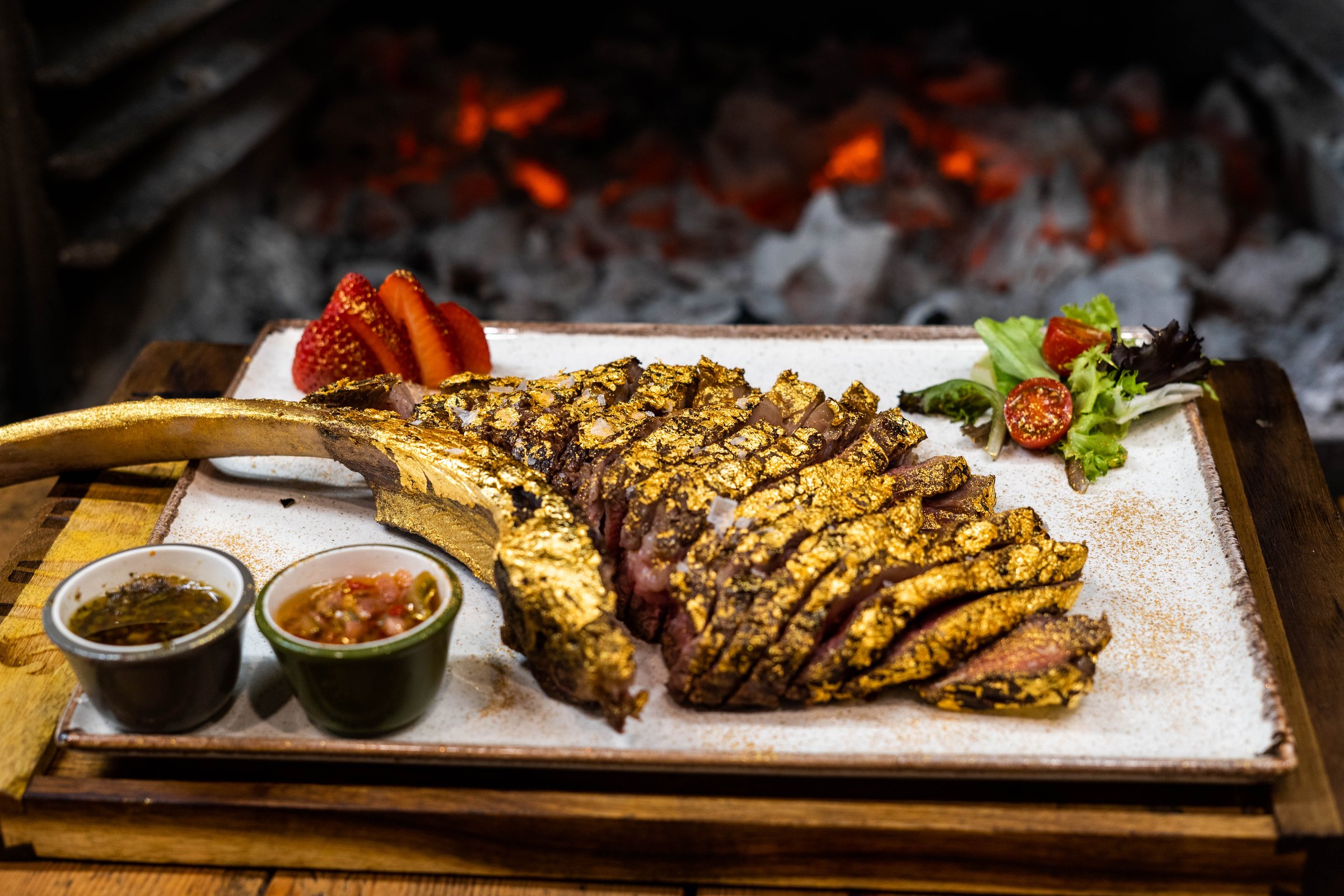 Premium beef tomahawk coated in edible gold
