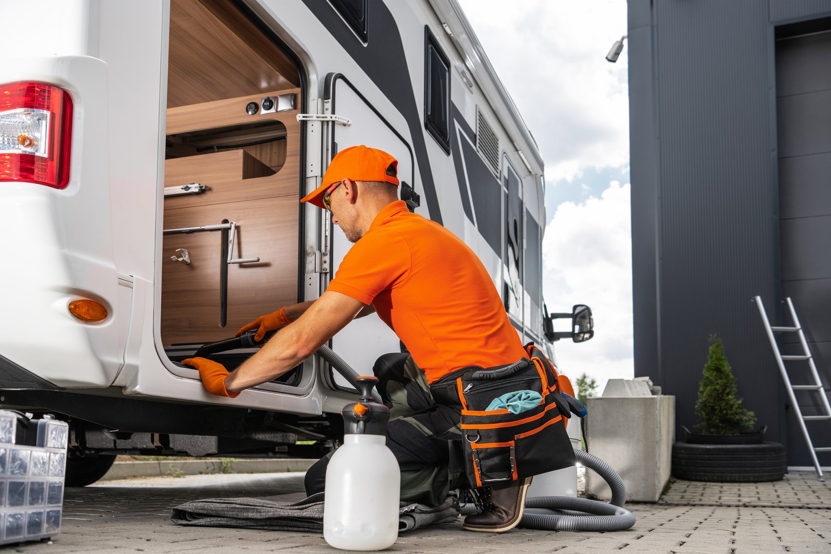 RV renting company worker is cleaning the interior of a recreational vehicle