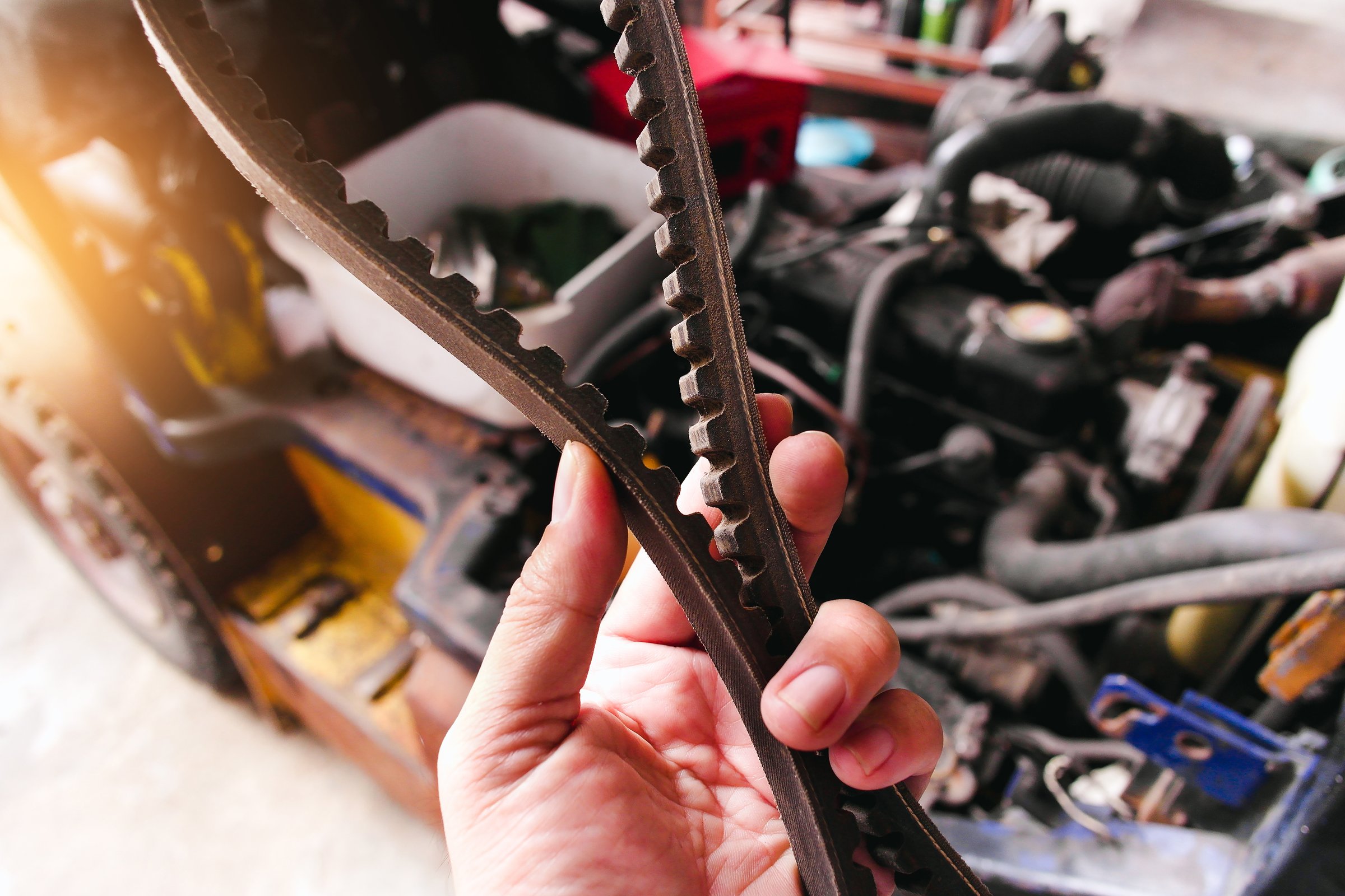 Expert mechanics at work on timing belts