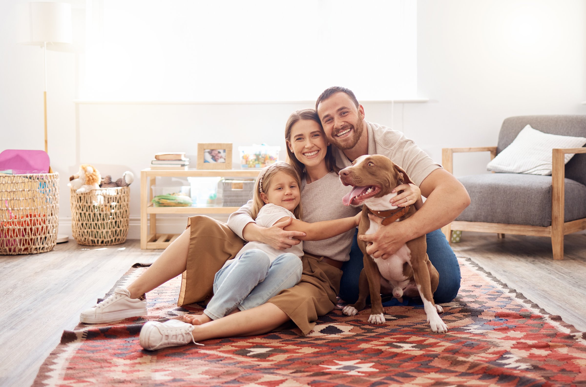 Happy family relaxing at home on clean area rug - professional residential rug cleaning services in Alpharetta GA