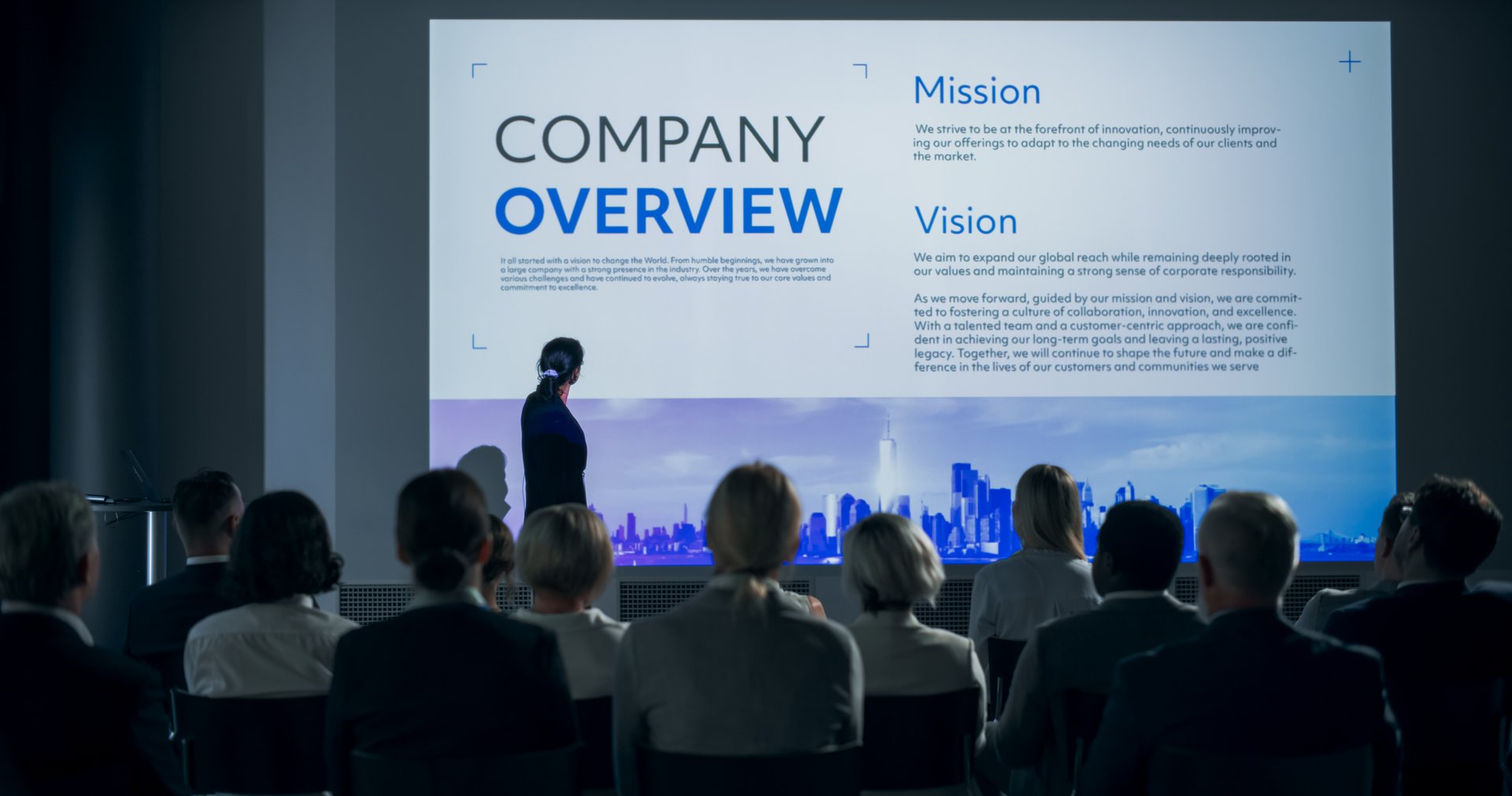 Corporate Event: Caucasian Female Tech CEO Giving Presentation To Colleagues or Investors In Conference Room Of Innovative Startup Office. Successful Speaker Talking About Business Vision And Mission.