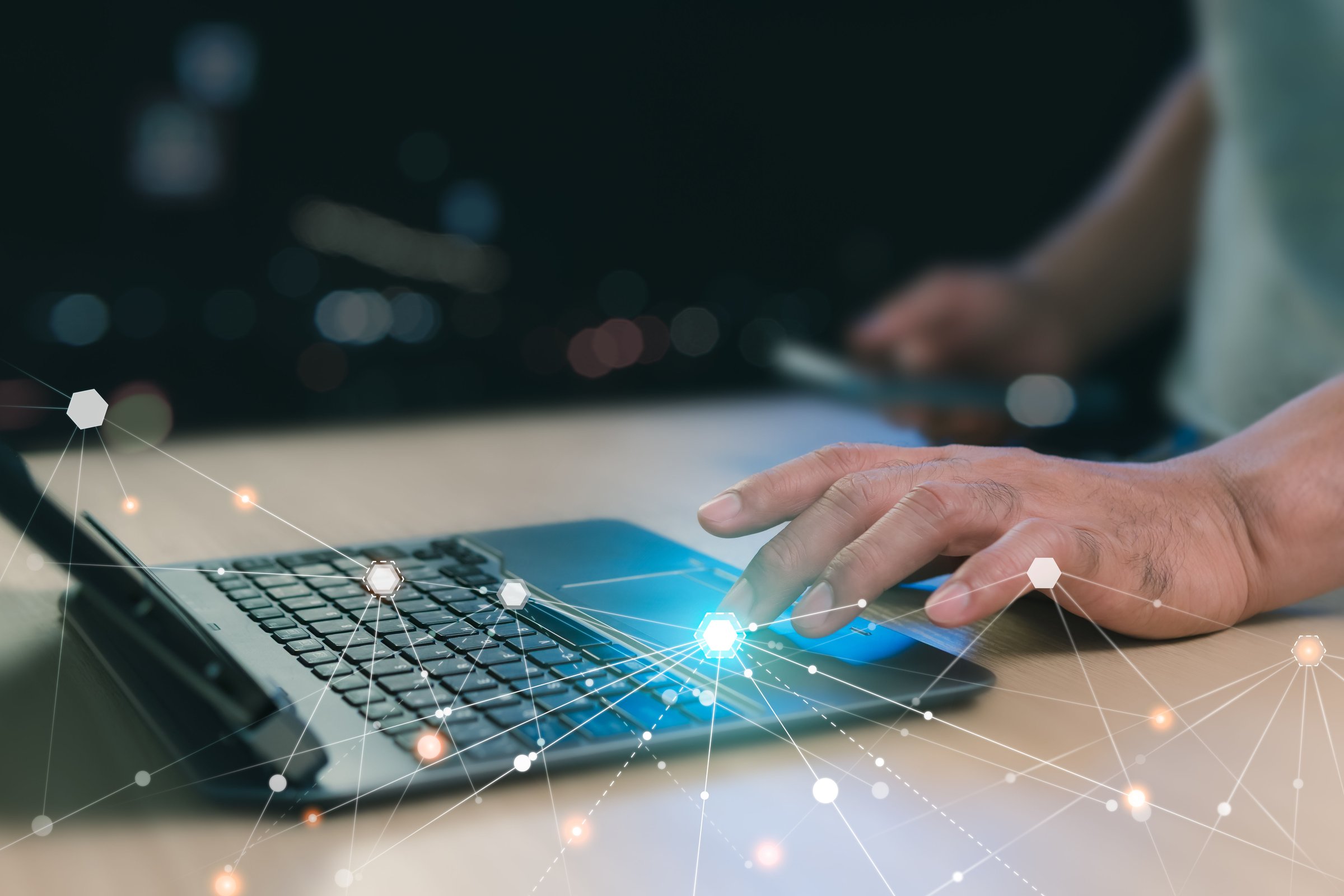 Close-up, Digital technology information network concept. Using a laptop to connect to the internet. A man using laptop play social media to search for information. Black background with bokeh.