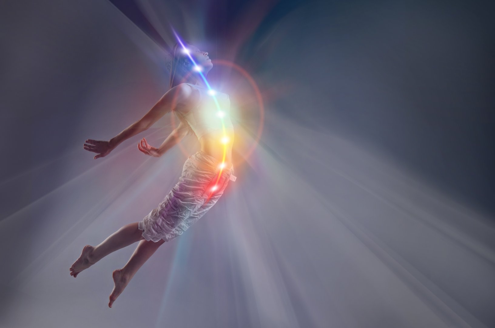 woman in yoga pose, glowing seven all chakra. Kundalini energy. girl practicing meditation outdoors. Silhouette.