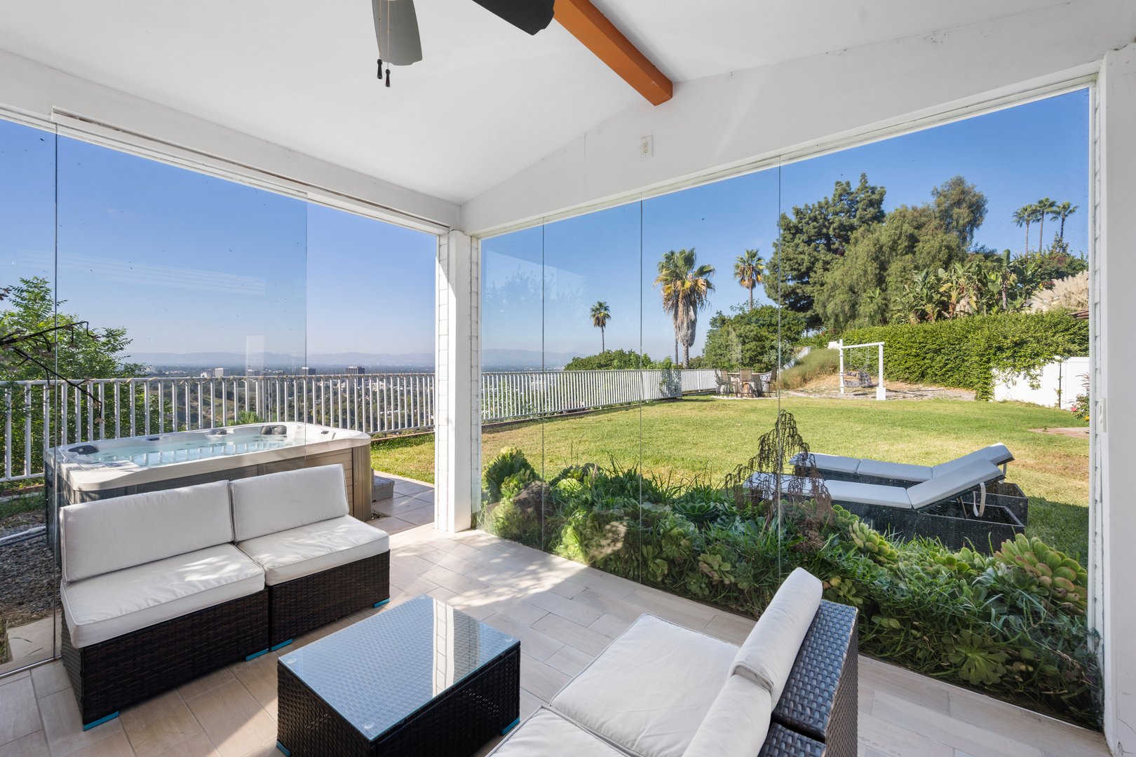 An outdoor patio furniture arranged by glass doors of a house in Hidden Hills, CA