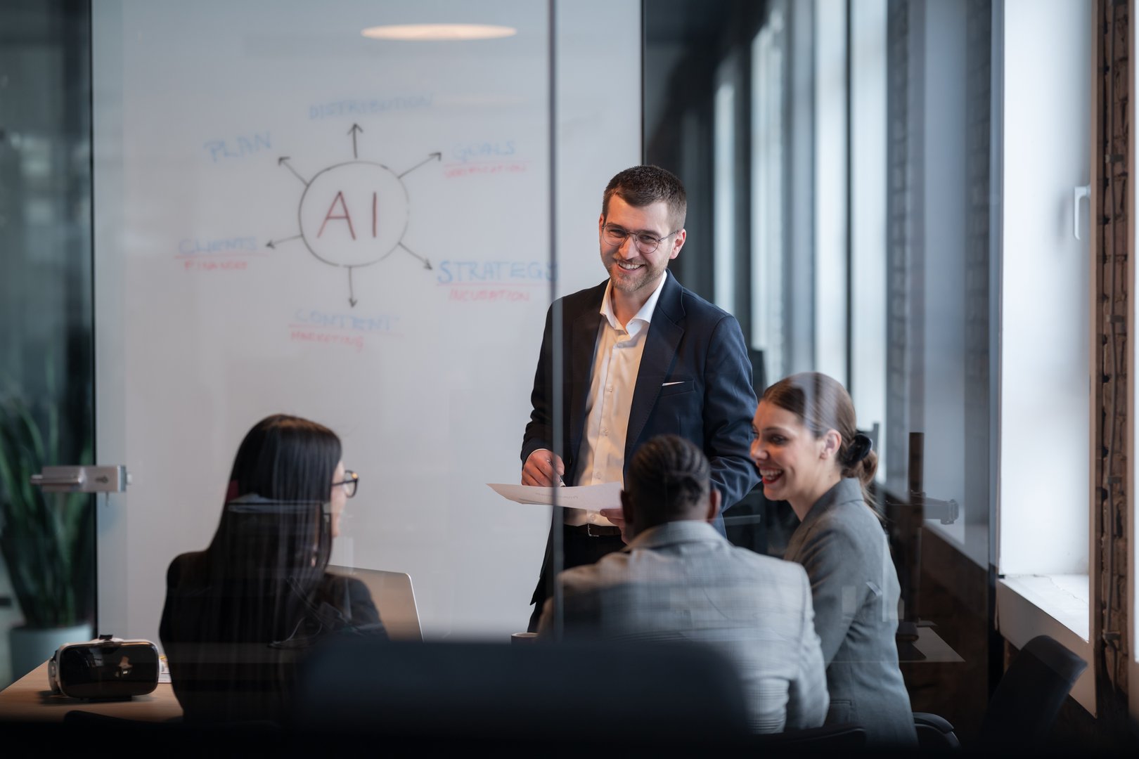 Diverse business team in a modern office during a meeting, discussing artificial intelligence strategy