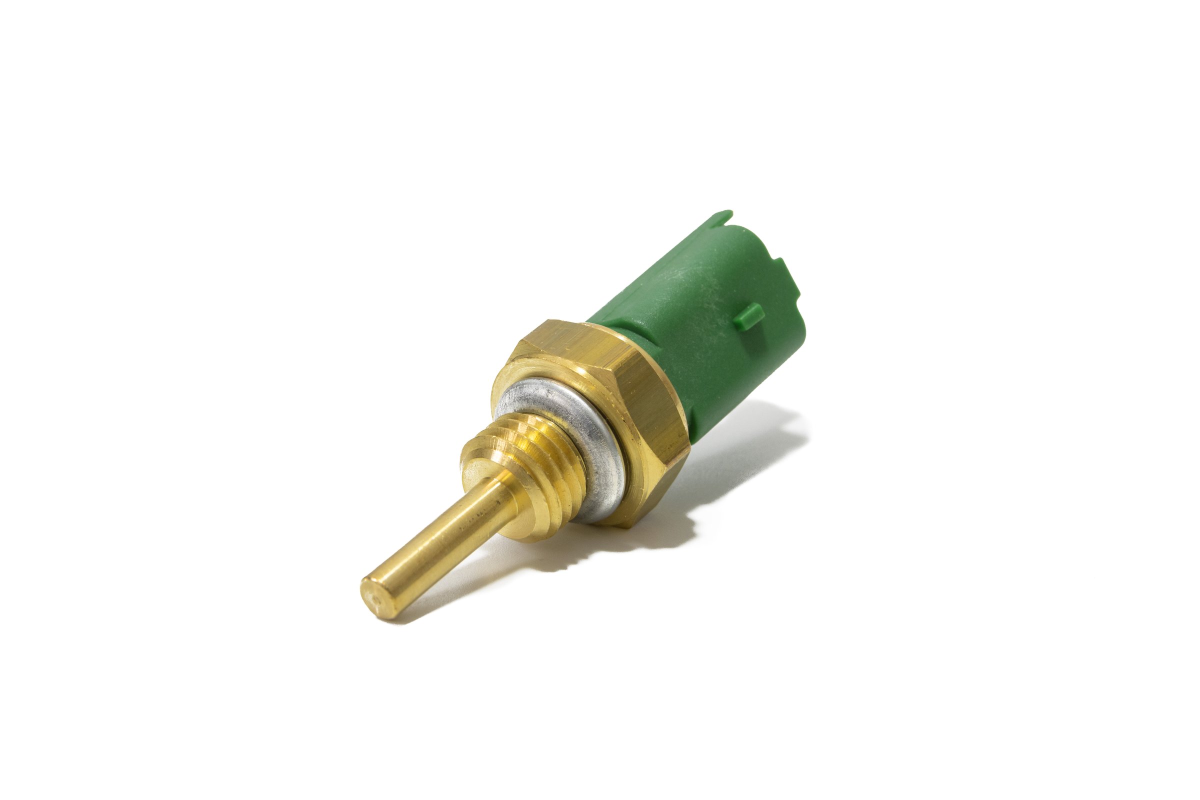 Car temperature sensor, a precision automotive component. Made of brass and green plastic, with an electrical connector and thread for engine installation. Isolated on a white background.