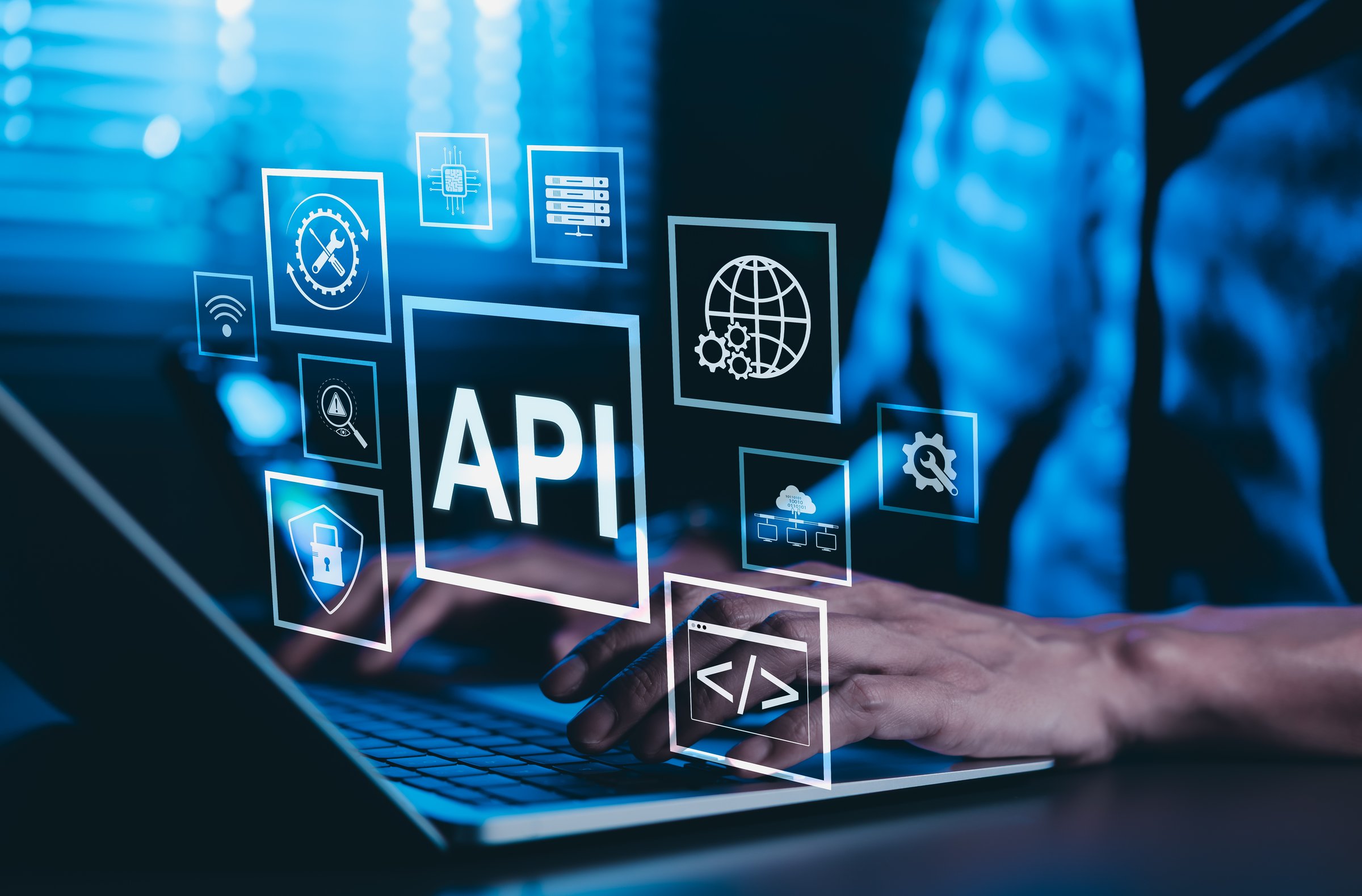 API Application Programming Interface Concept. A programmer types on a laptop, interacting with digital icons representing API development, security, and cloud computing. Application Software Tool,