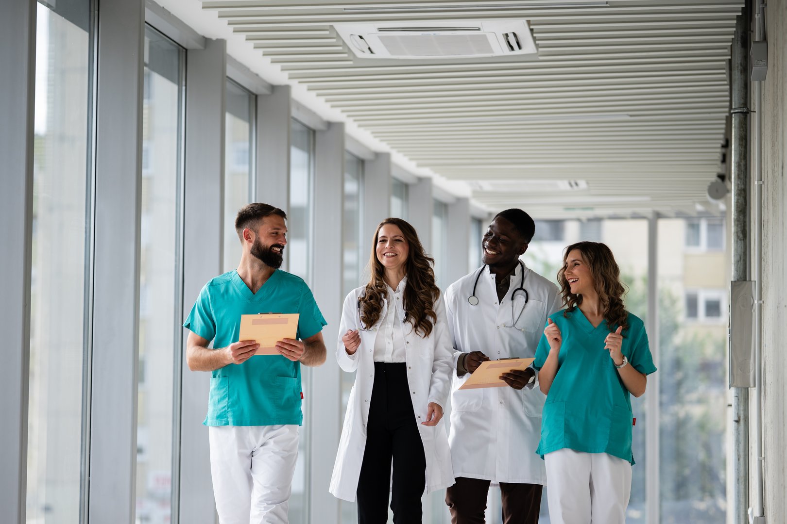 Healthcare professionals collaborating in hospital hallway
