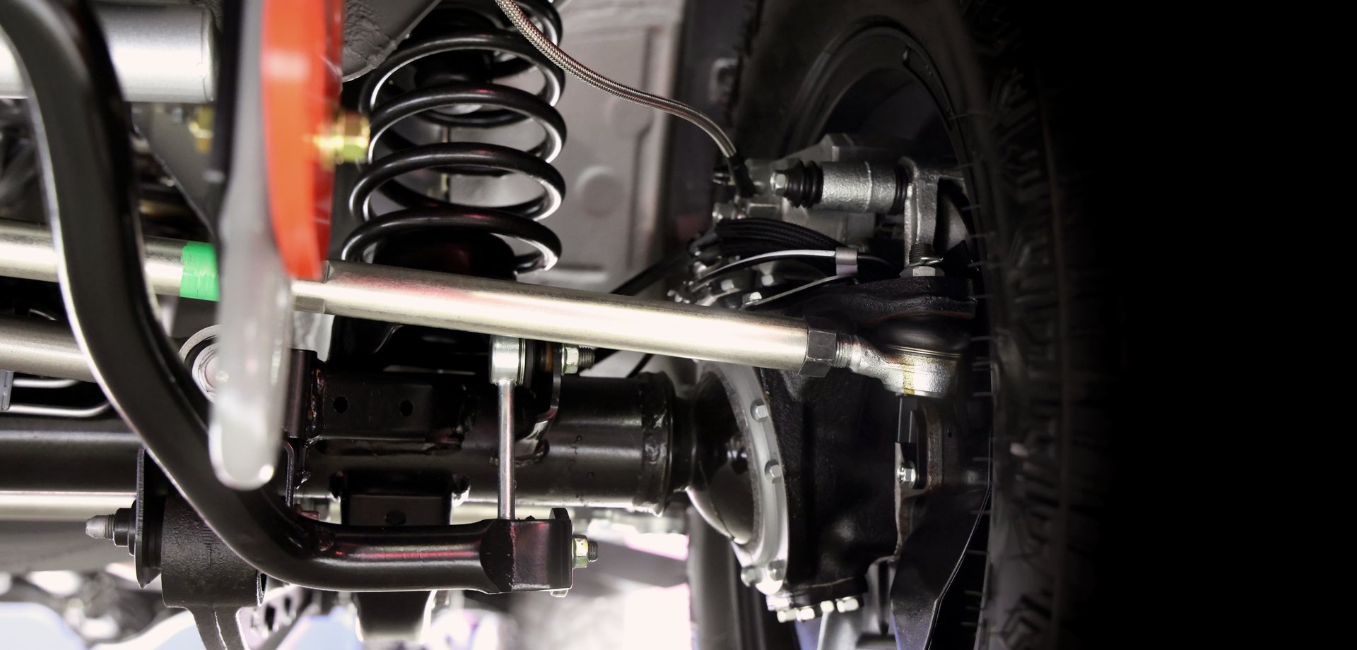 Car suspension part. Close up of a rear car suspension and exhaust system. such as coil springs link arms axle housing and performance exhaust. For auto engineering or car suspension part industry use