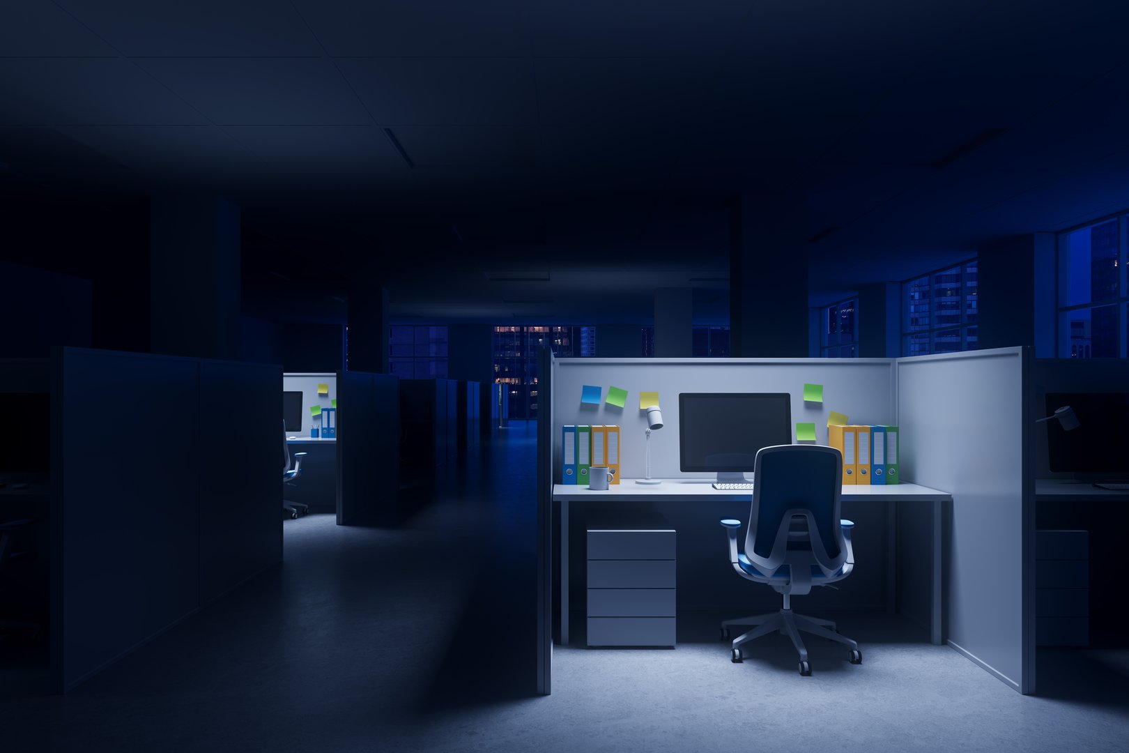 Cubicle workspace with lit computer