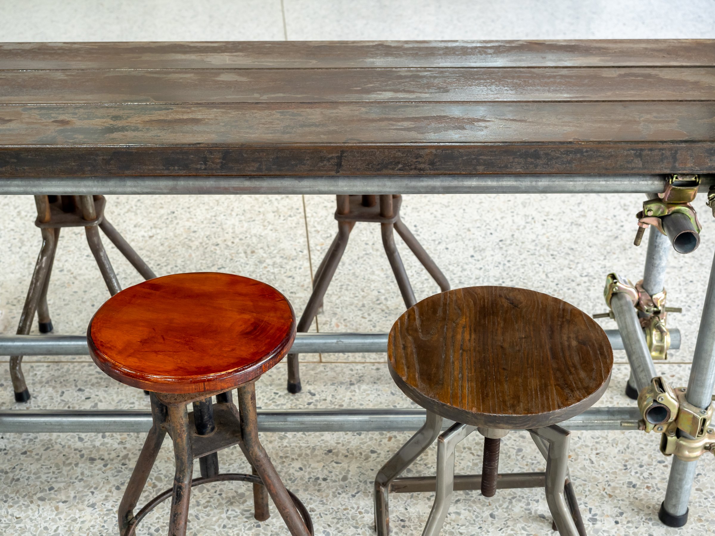 Two empty vintage round chairs under wood table decorated on concrete floor background