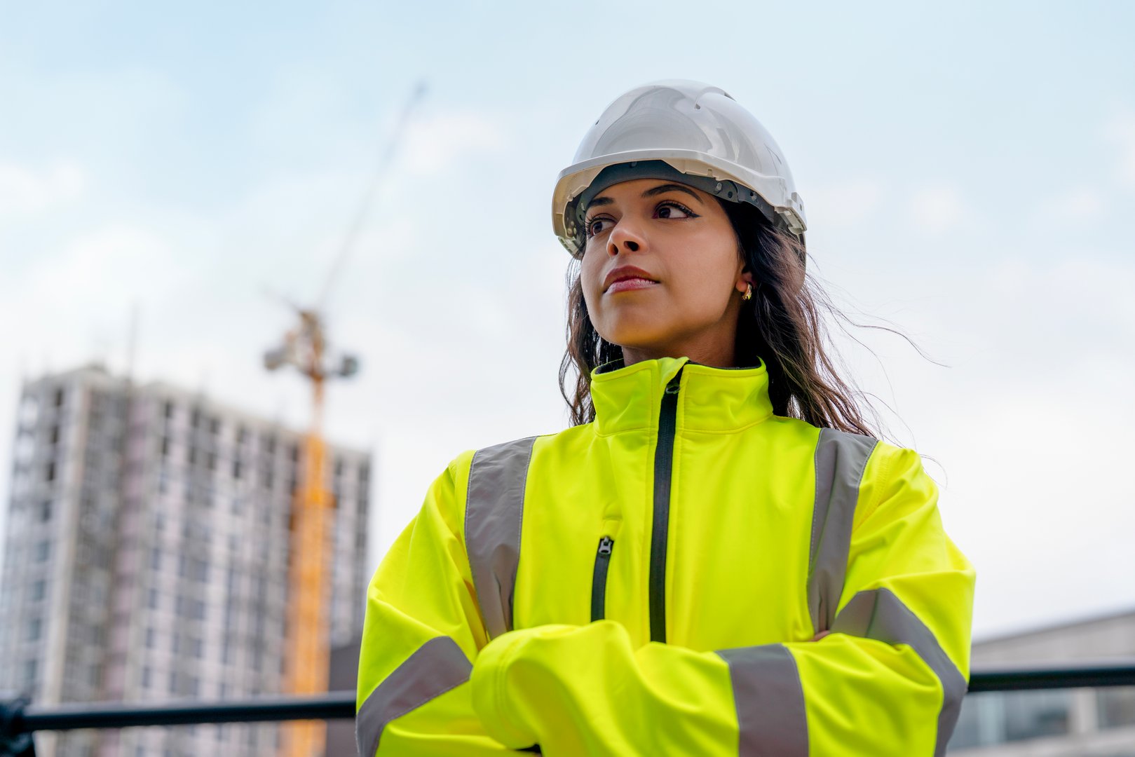 Portrait of female construction worker at a busy construction site