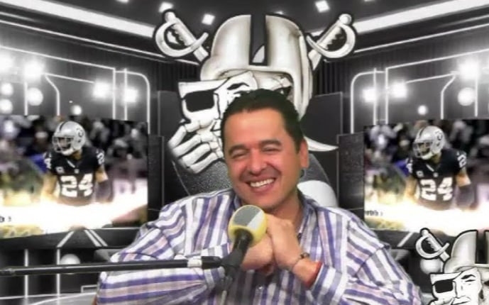 Smiling man in plaid shirt with microphone, sports-themed background featuring football player and helmet design.