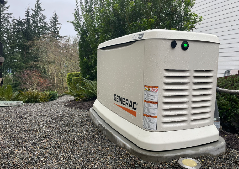Cougar Mountain Generac standby generator installation - exterior view showing the Generac generator unit and transfer switch mounted on concrete pad