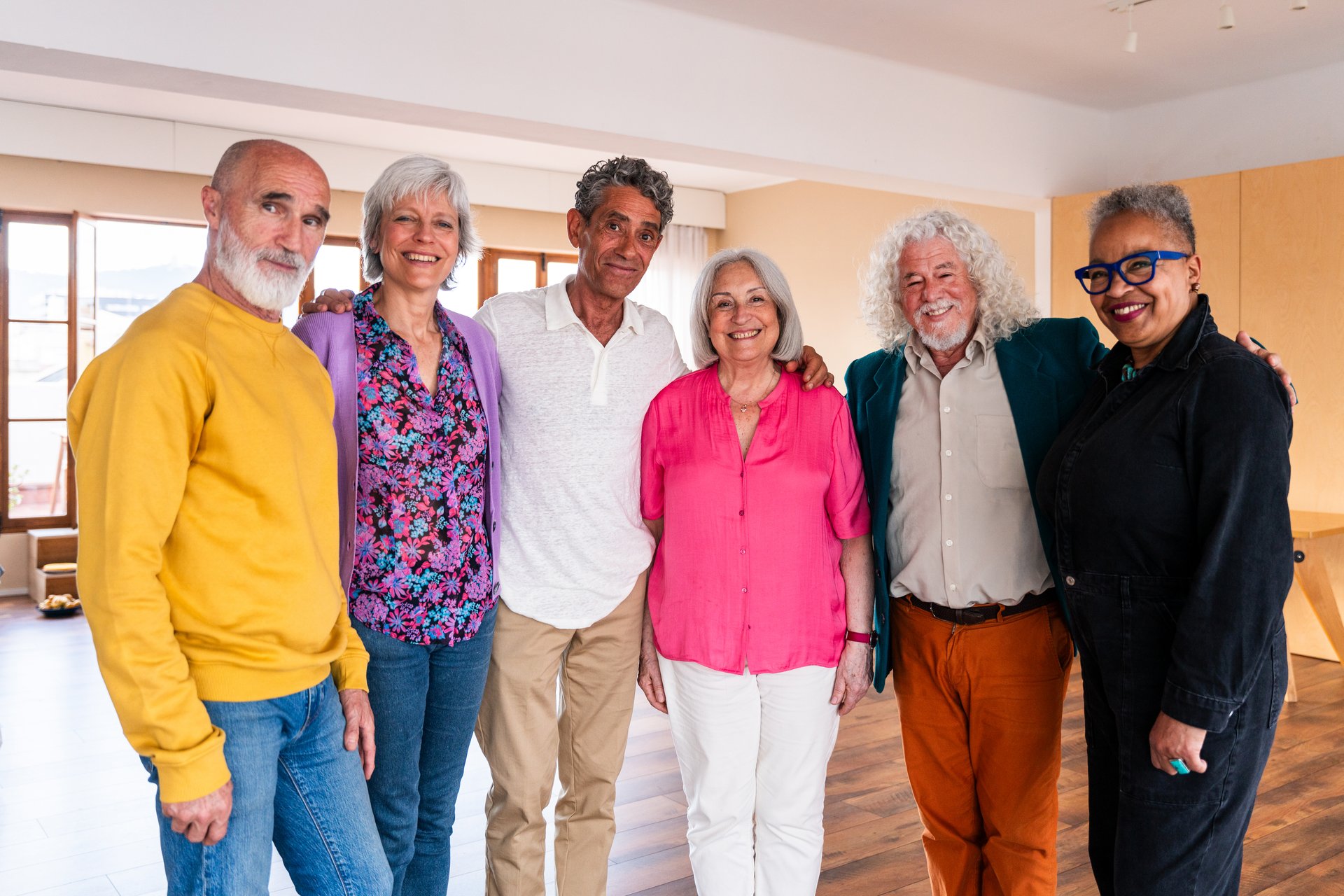 Group of happy senior friends bonding at home for dinner party - Cheerful and youthful old mature multiethnic people having fun