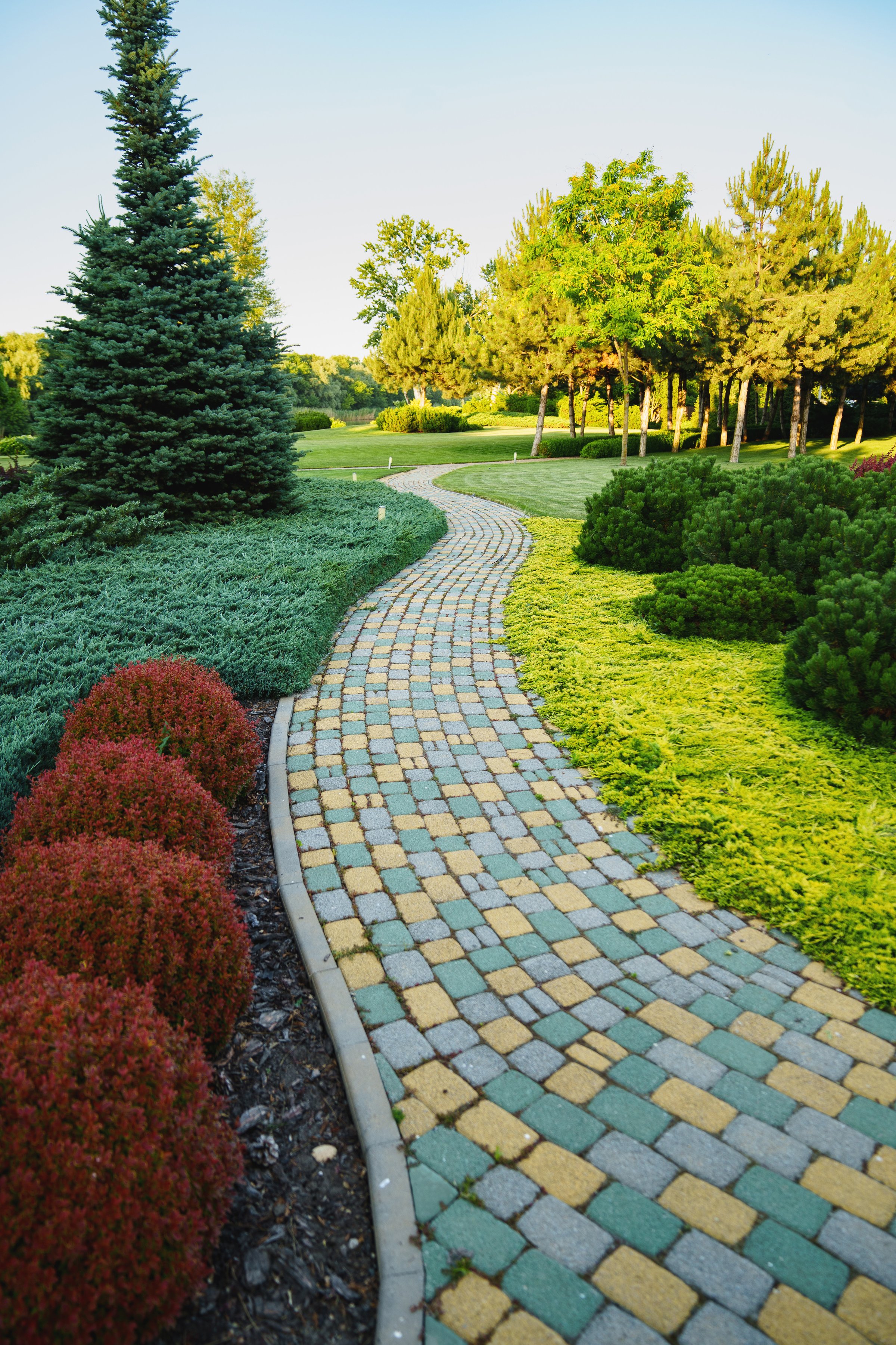 Landscaping in the park. stone-paved path in the garden. landscape designer services.
