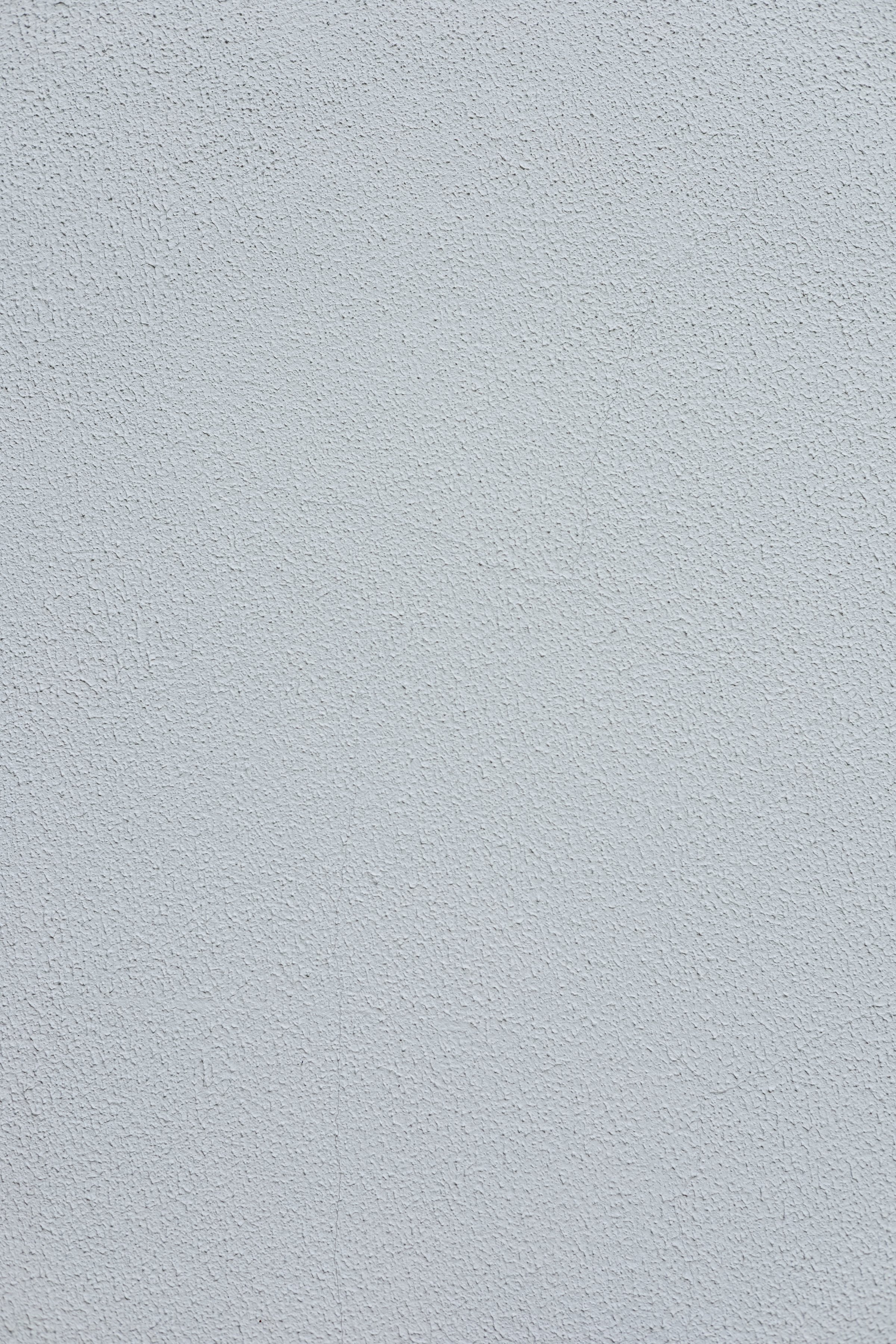 A smooth, light gray textured wall surface.