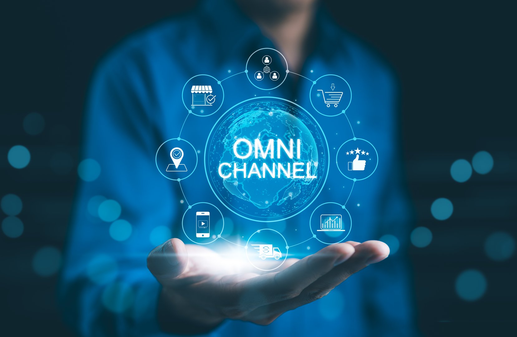 Omni Channel Marketing Concept. Businessman holding digital representation of omni-channel marketing, e-commerce, delivery, social media, analytics, customer engagement, and customer service icons