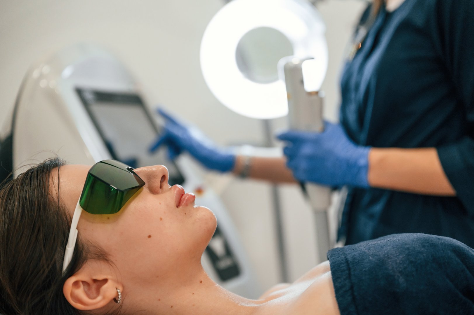 Getting photo rejuvenation procedure at cosmetology clinic. Women in beauty salon.