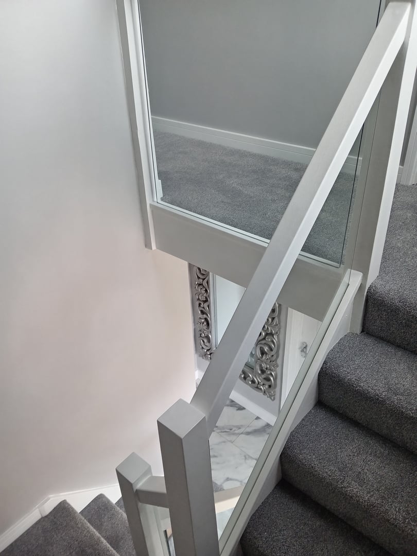 The stylish modern interior features an open floor plan, warm wood minimalist furniture. The spacious living room with a large sofa and sofa lighting creates a cozy atmospere.