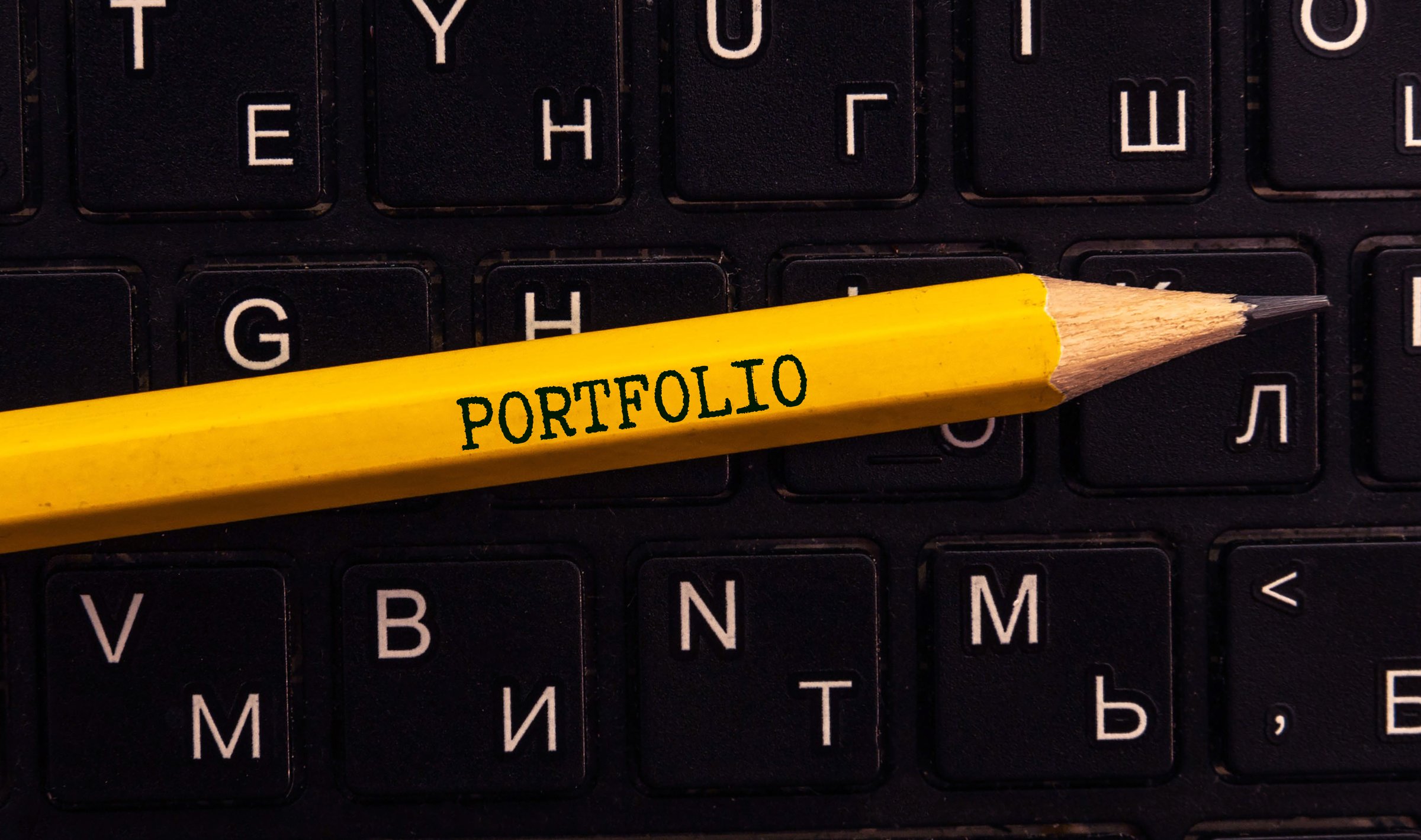 Tablet pc with text Portfolio which holding man