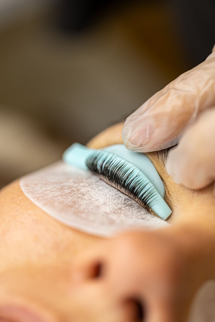 The make-up artist does eyelash lamination