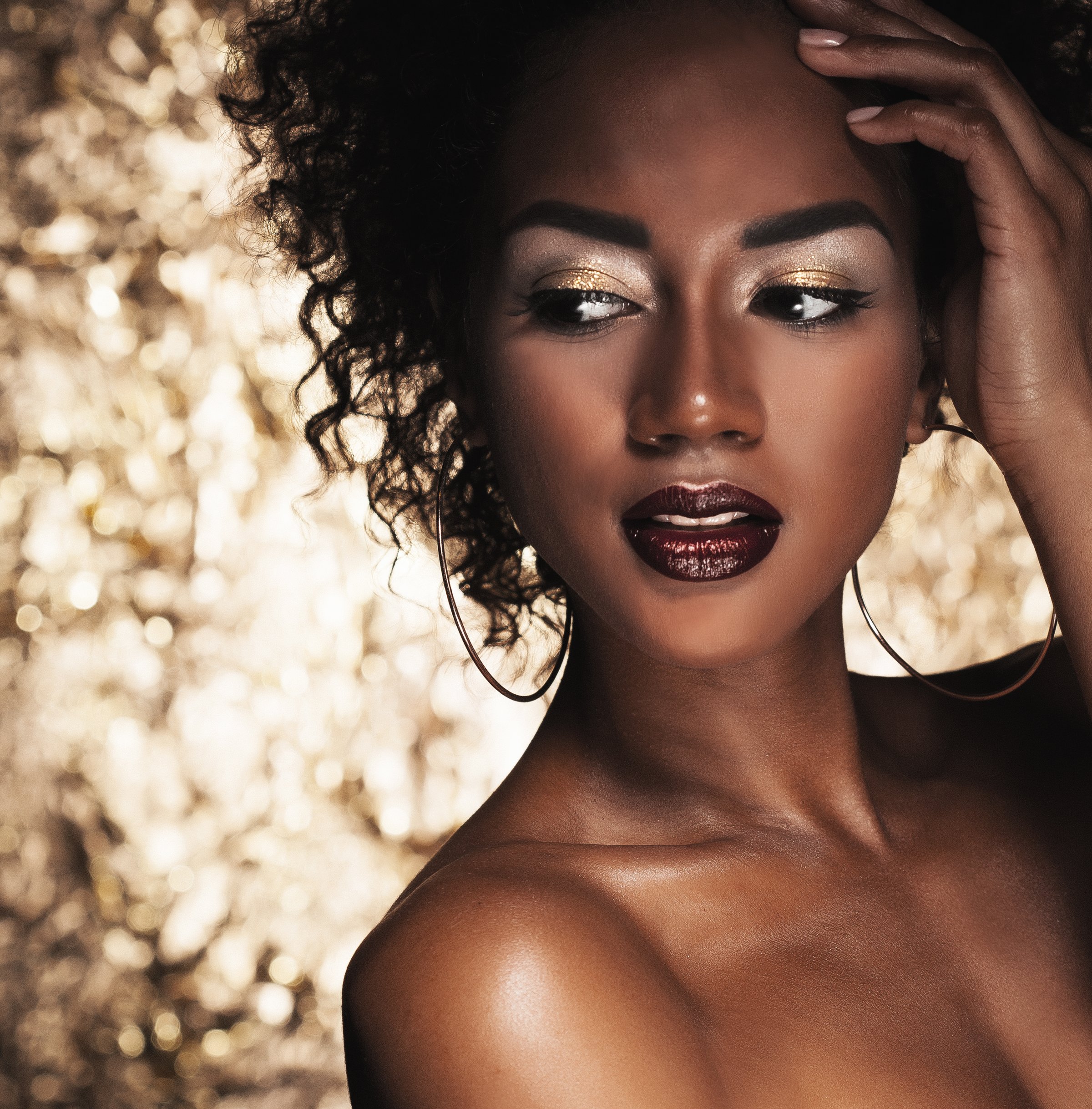 Stunning Portrait of an African American Black Woman over golden background, young and beauty