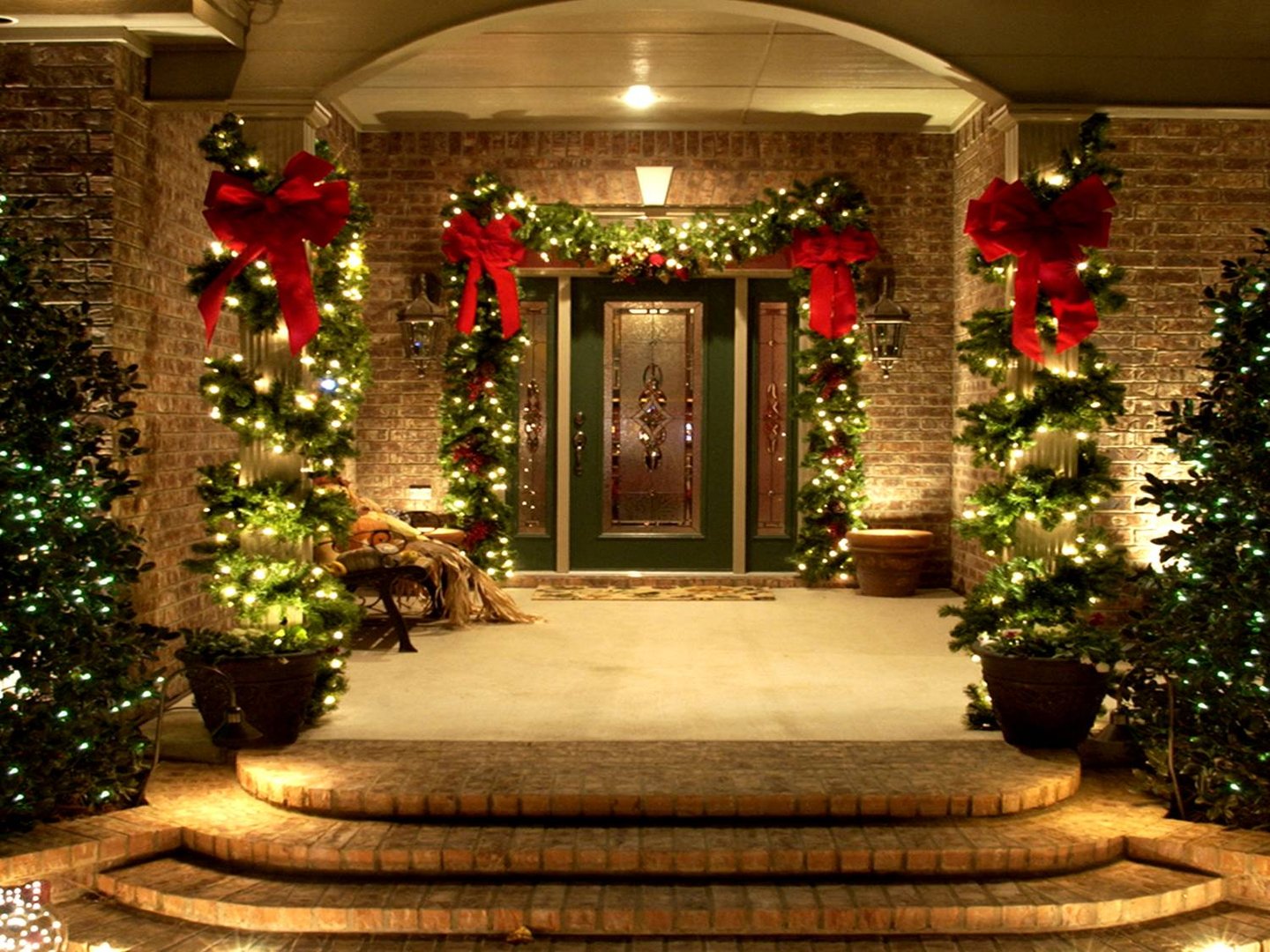 From above of decorated garland of ornamental glowing yellow shiny led lights illuminating in ball shape in festive season along with bokeh golden background at night