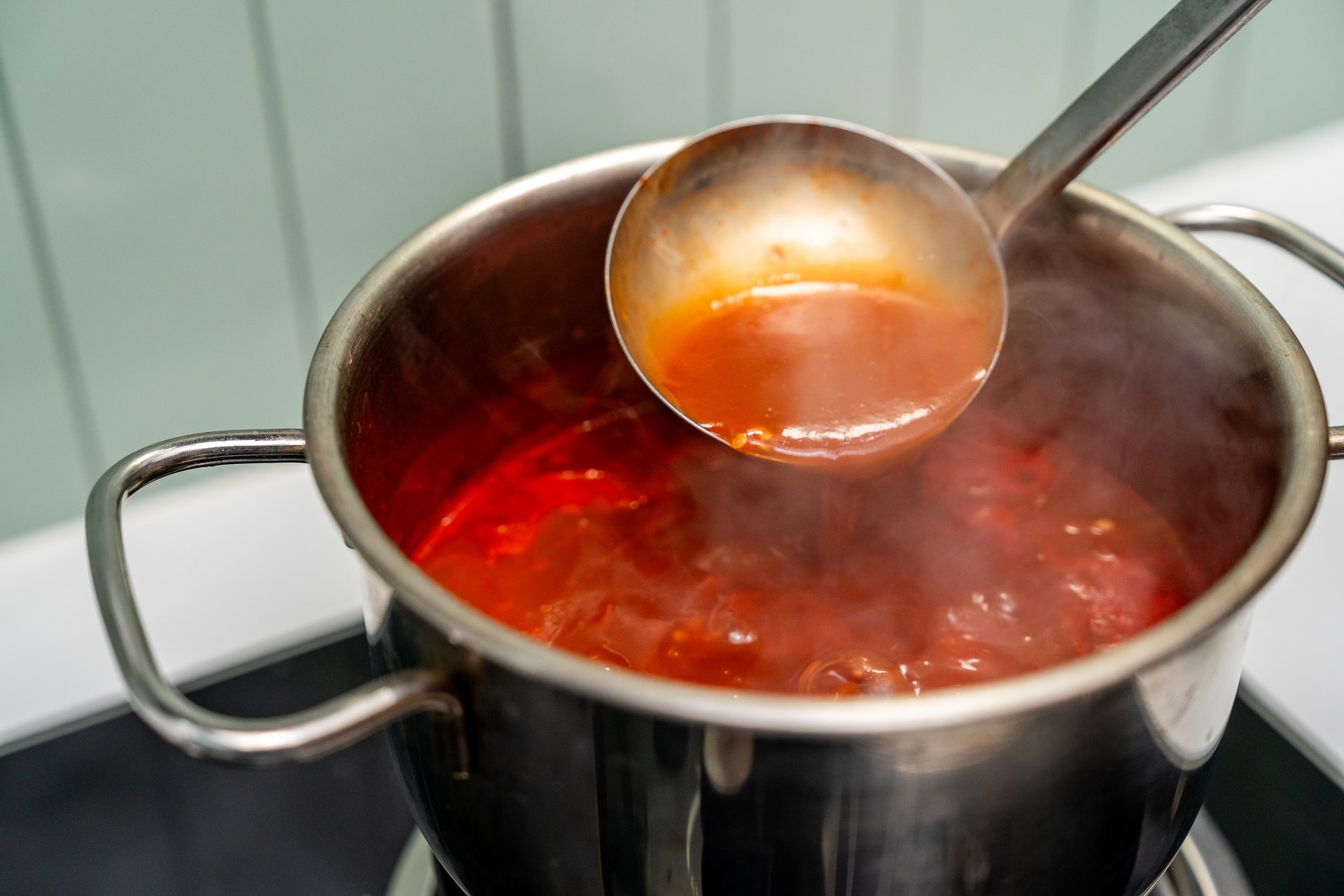 Rich tomato sauce simmer gently in a pot coat pasta. Thick vibrant tomato sauce bubbles in a pan filling the kitchen. Homemade tomato sauce bubbling beautifully on the stove awaits its pasta pairing